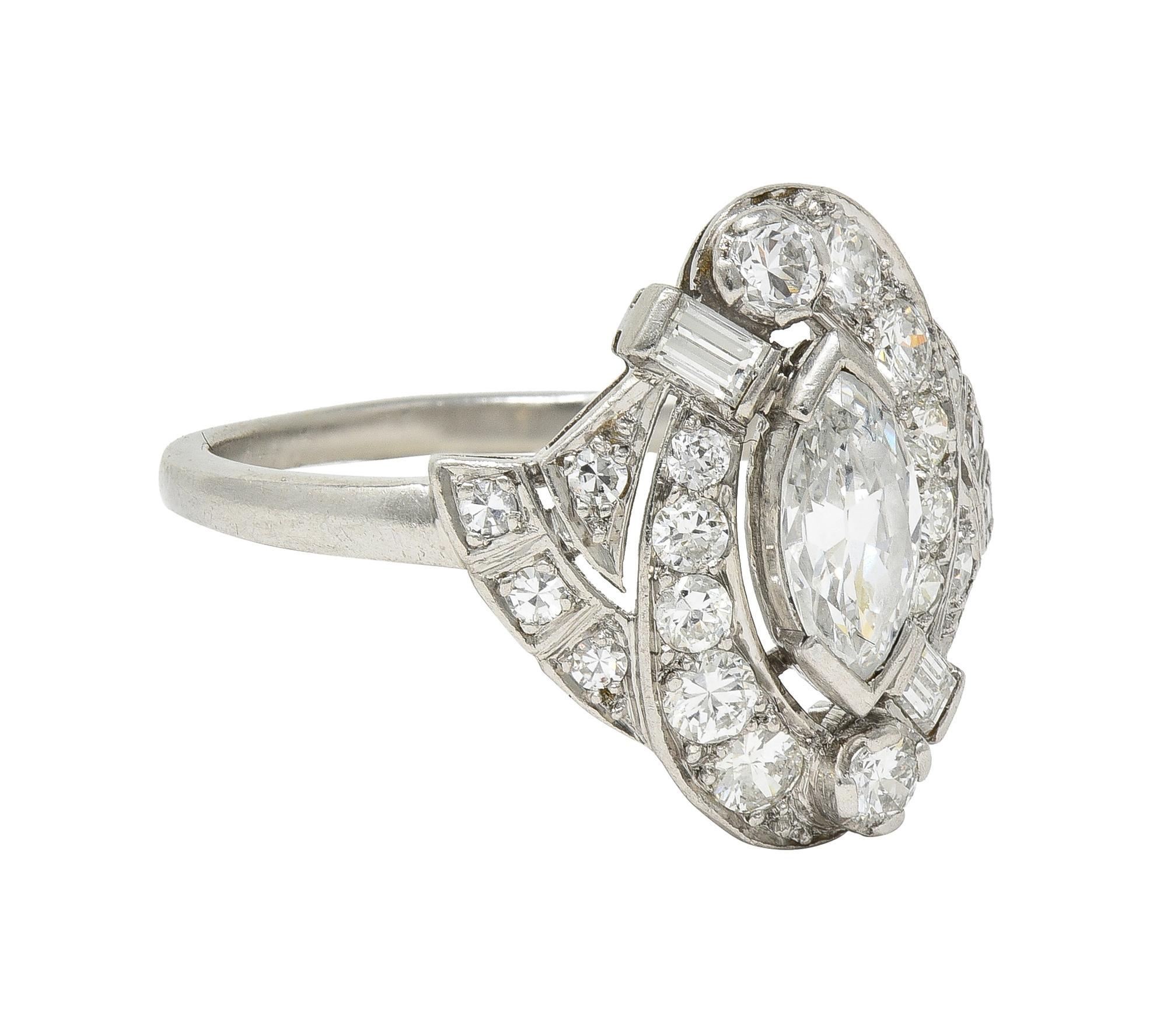 Centering a marquise cut diamond weighing approximately 0.72 carat - H color with VS2 clarity
Tab set with a recessed pierced swirl motif surround bead and bar set with diamonds
Transitional, single, and baguette cut 0- weighing approximately 0.54