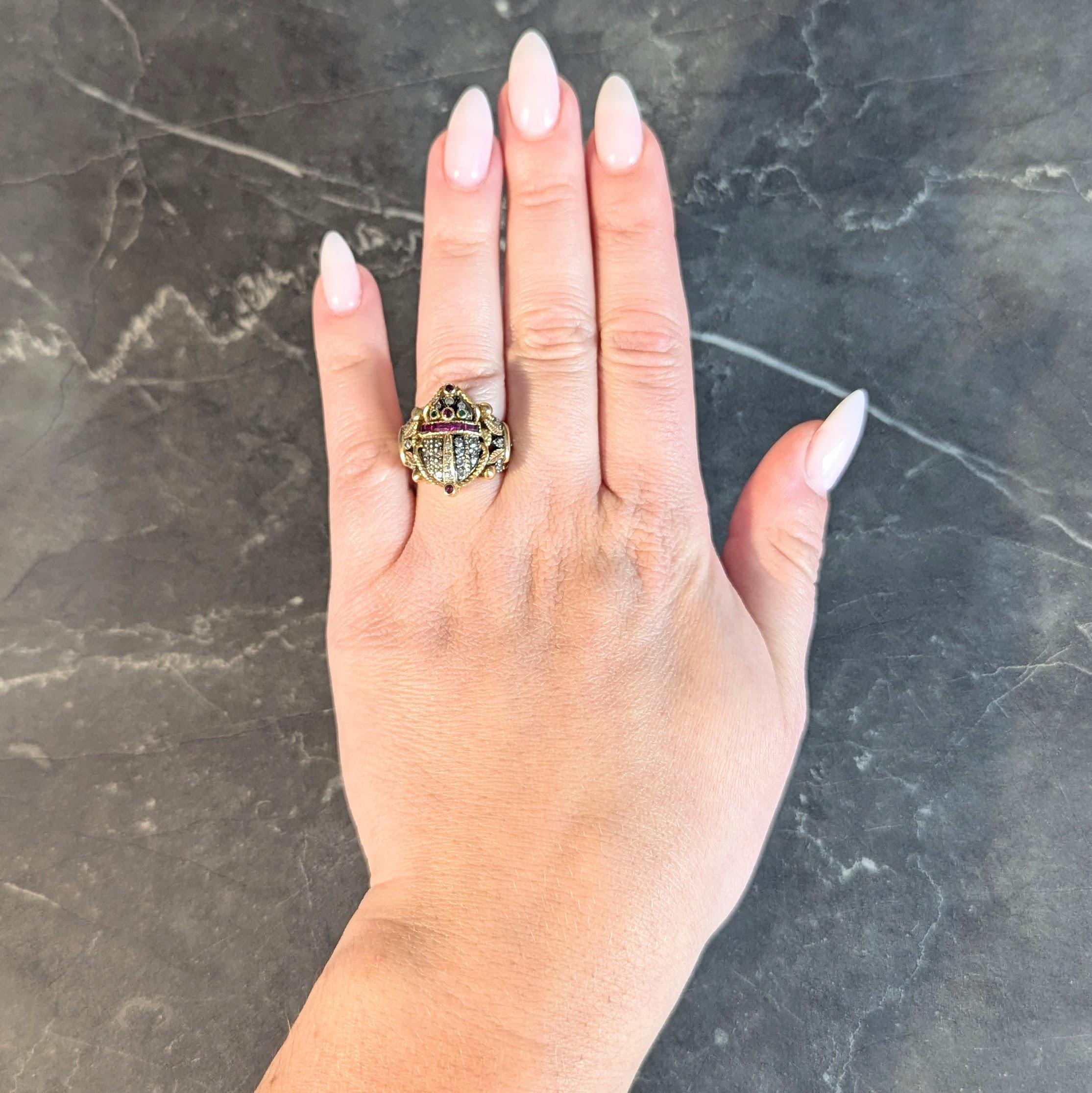 Designed as a stylized scarab with spindly legs flanked by lotus motif shoulders
Featuring bead set single cut diamonds in rows along back and across lotus
Weighing approximately 0.64 carat total - eye clean and metal backed
Accented by a row of