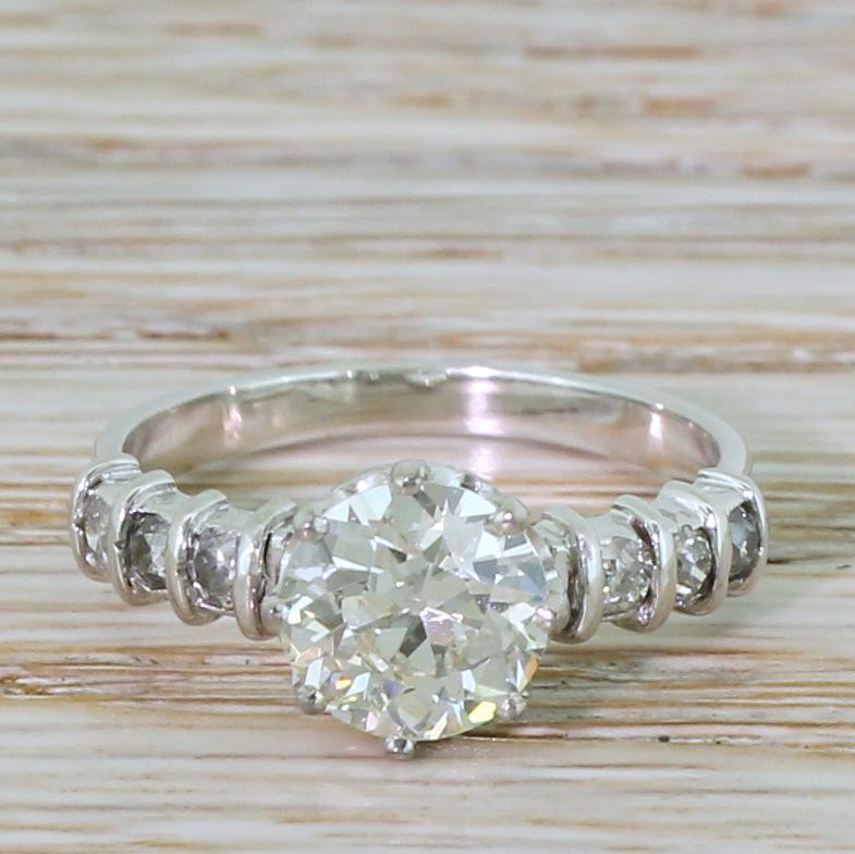 An effortlessly stunning old European cut diamond engagement ring. The centre stone – graded by IGI, Antwerp as K colour, VS2 clarity – is bright and absolutely glowing. The diamond sits nice and low to the finger in an eight claw coronet collet,