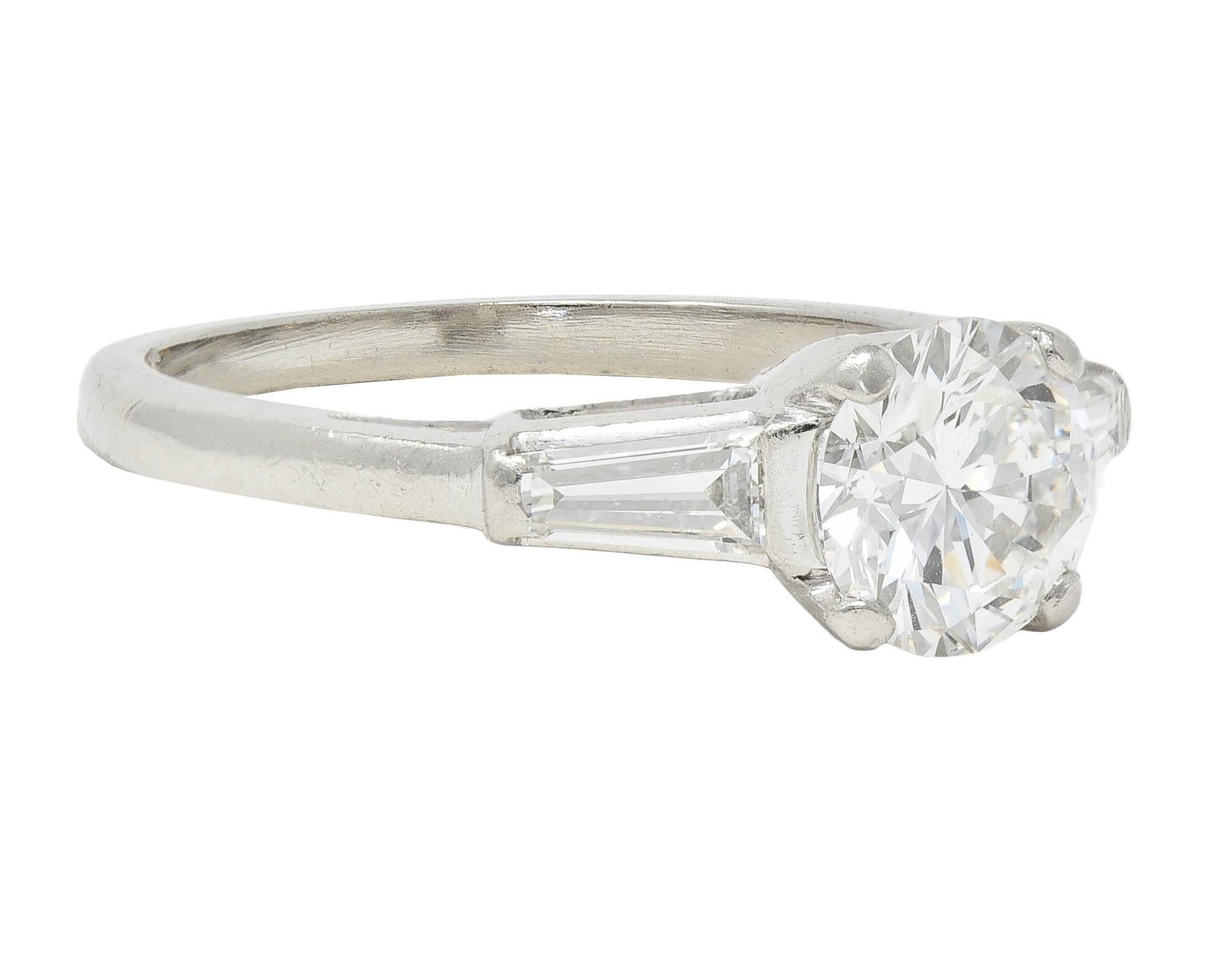 Centering a transitional cut diamond weighing approximately 1.06 carats - G color with VS clarity
Basket set and flanked by cathedral shoulders bar set with tapered baguette cut diamonds
Weighing approximately 0.30 carat total - G/H color with VS
