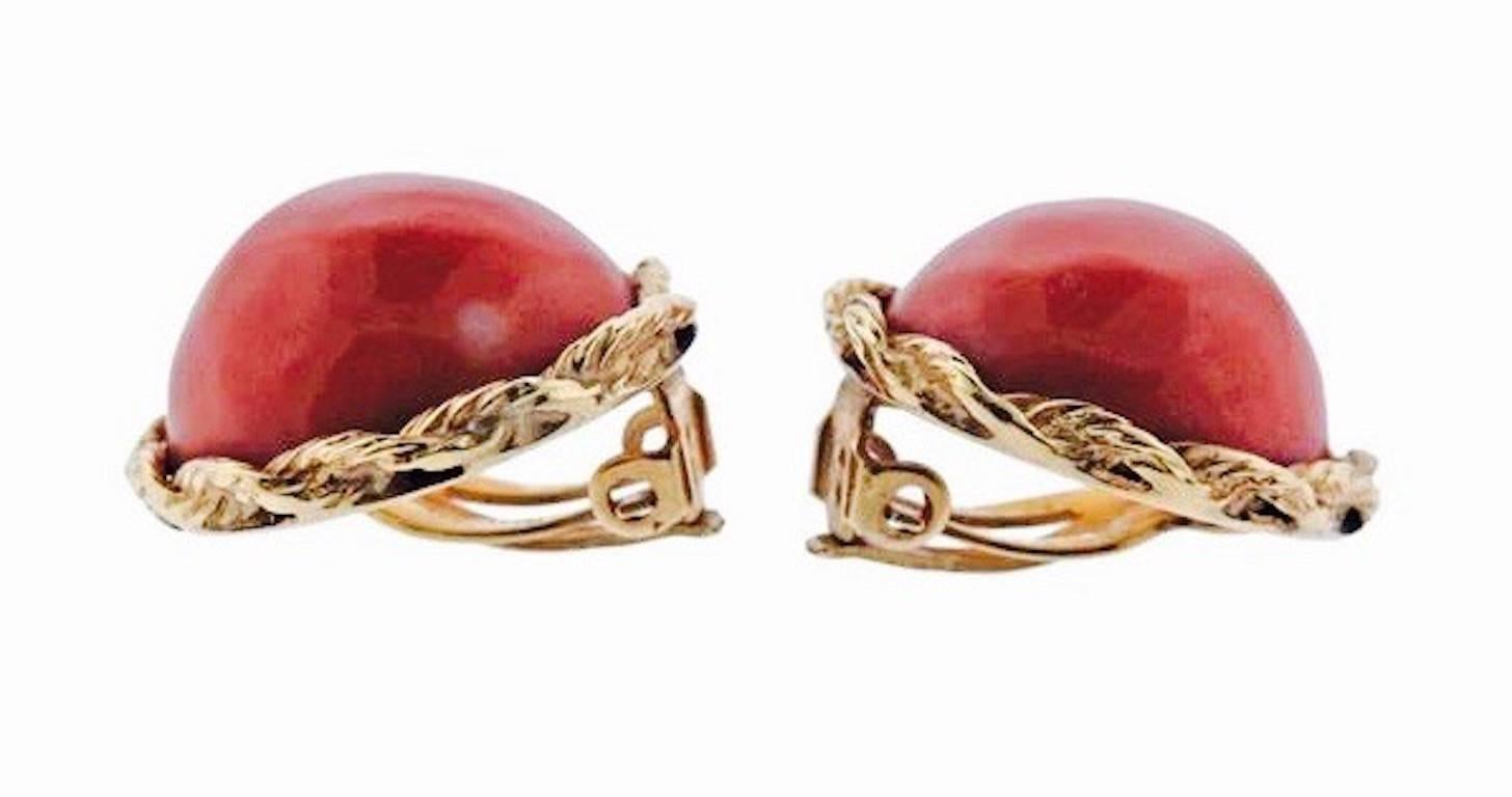 These beautiful estate retro earrings feature two large red coral cabochons set in 14k yellow gold roping halo.   The earrings are marked 