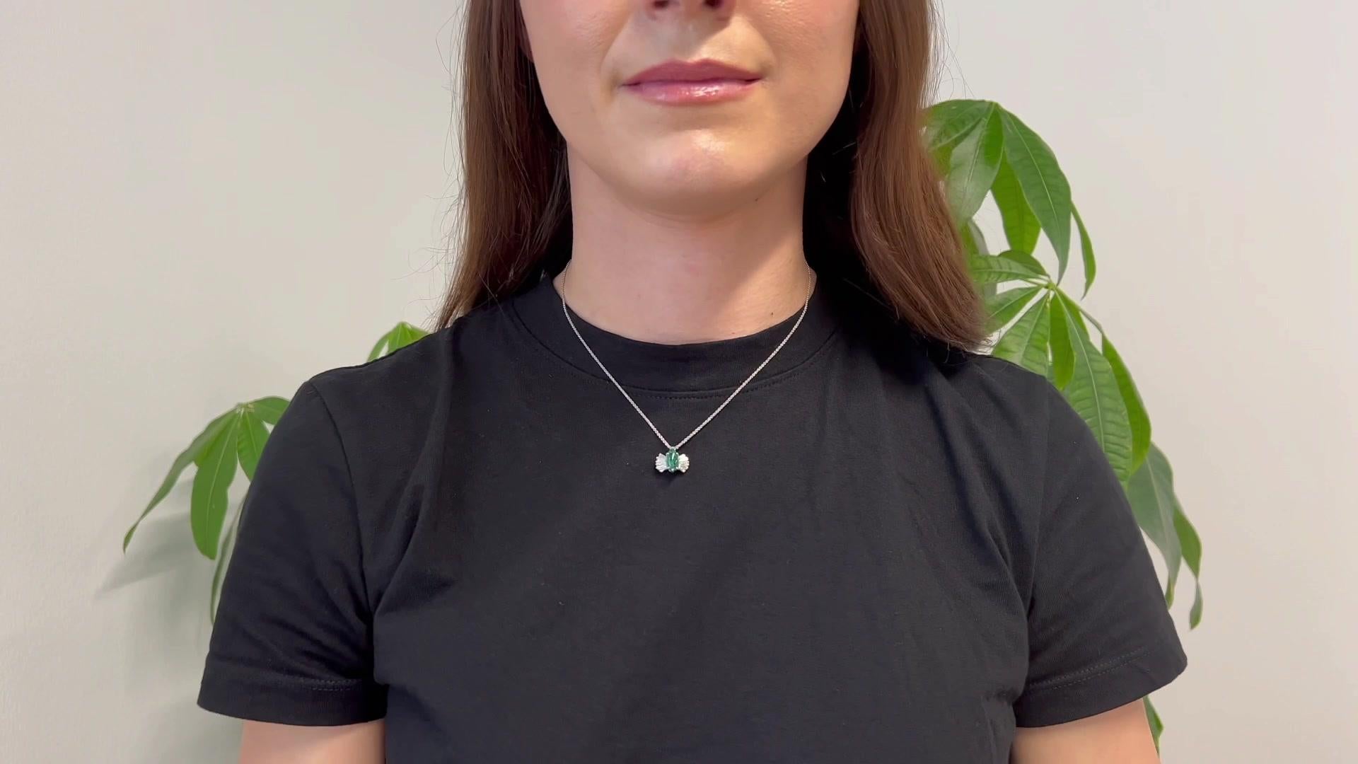 One Mid Century 1.41 Carats Emerald Platinum Pendant Necklace. Featuring one cabochon cut emerald of 1.41 carats. Accented by 10 tapered baguette cut diamonds with a total weight of approximately 0.45 carat, graded F color, VS clarity. The pendant