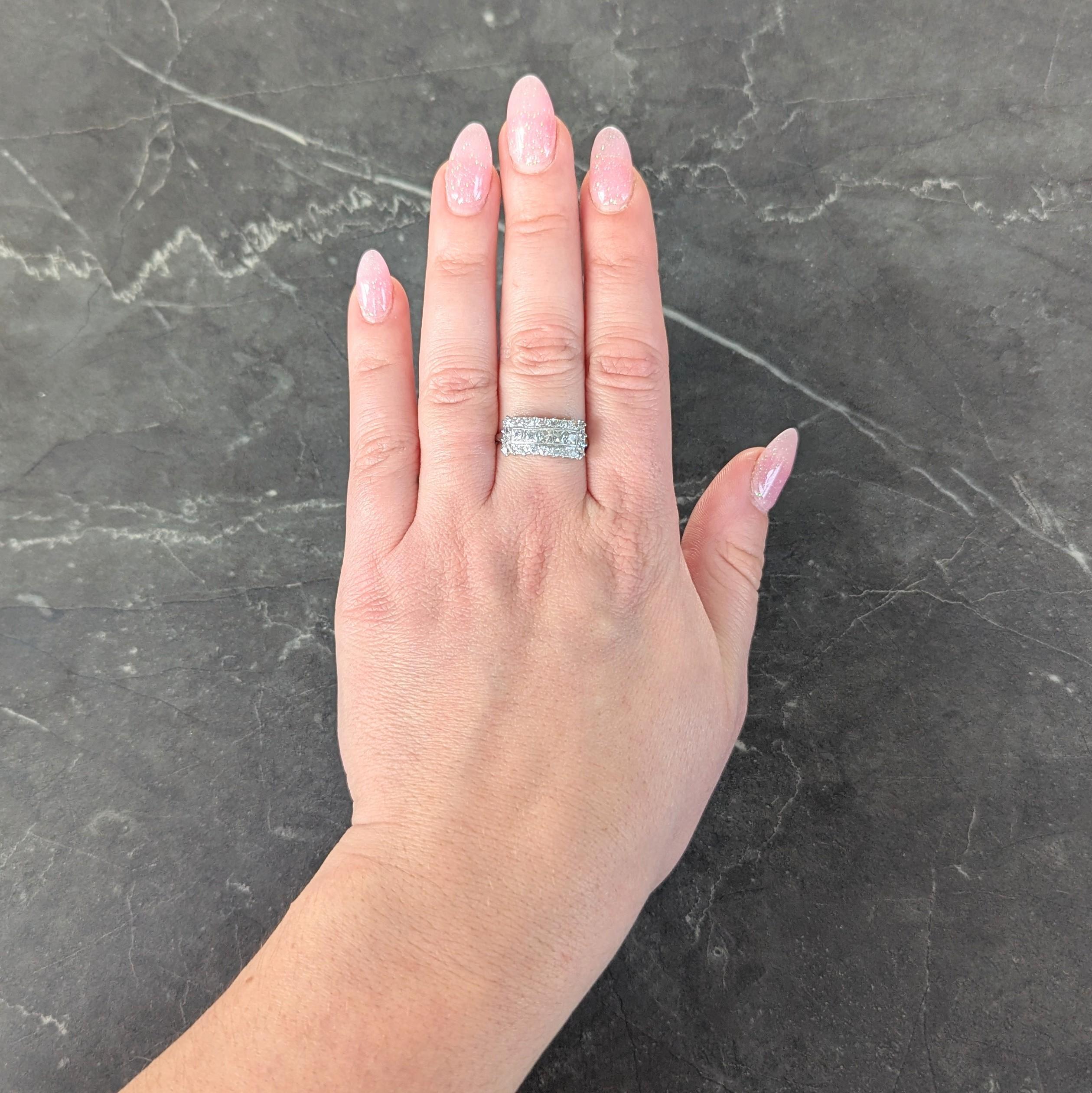 Centering a row of French cut diamonds weighing approximately 0.75 carat total
G/H color with VS2 clarity - channel set with single cut diamond halo surround
Weighing approximately 0.66 carat total - well matched to center
Prong set with grooved
