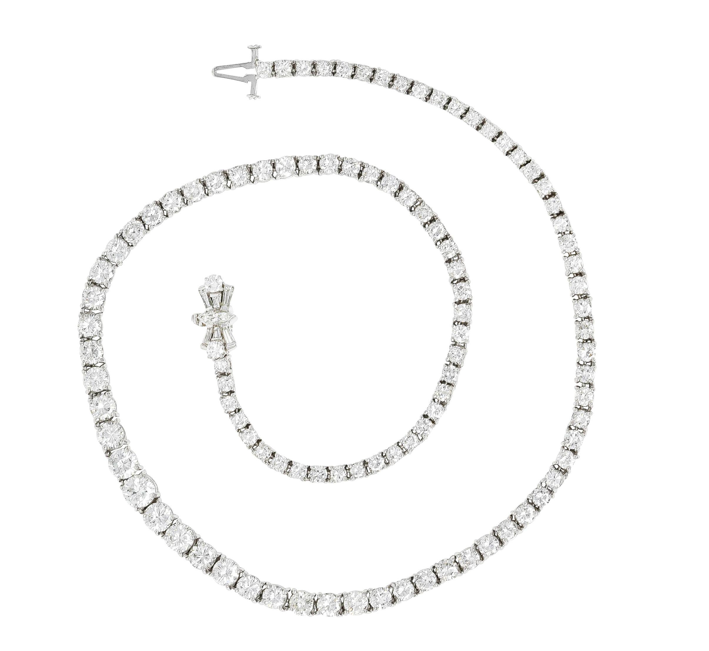 Designed as a graduated strand of prong set round brilliant cut diamonds. Center weighs approximately 0.55 carat total - H color with SI1 clarity. With additional round brilliant, navette, and baguette cut diamonds. Weighing approximately 13.60