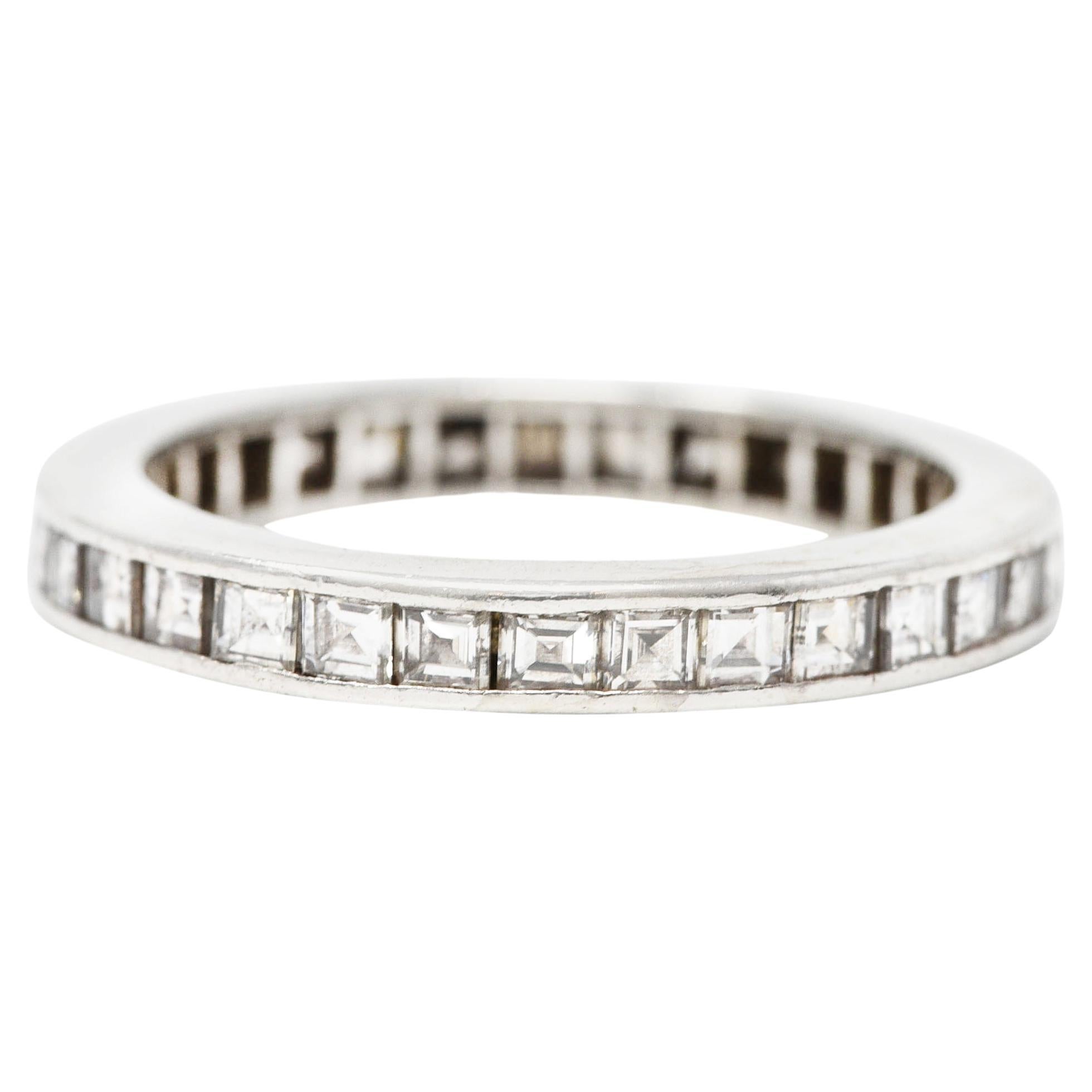 Featuring square step cut diamonds channel set fully around. Weighing approximately 1.48 carats total. H/I color with VS1 clarity. With high polish platinum finish. Tested as platinum. Circa: 1950's. 
Ring size: 6 1/4 and sizable. Measures North to
