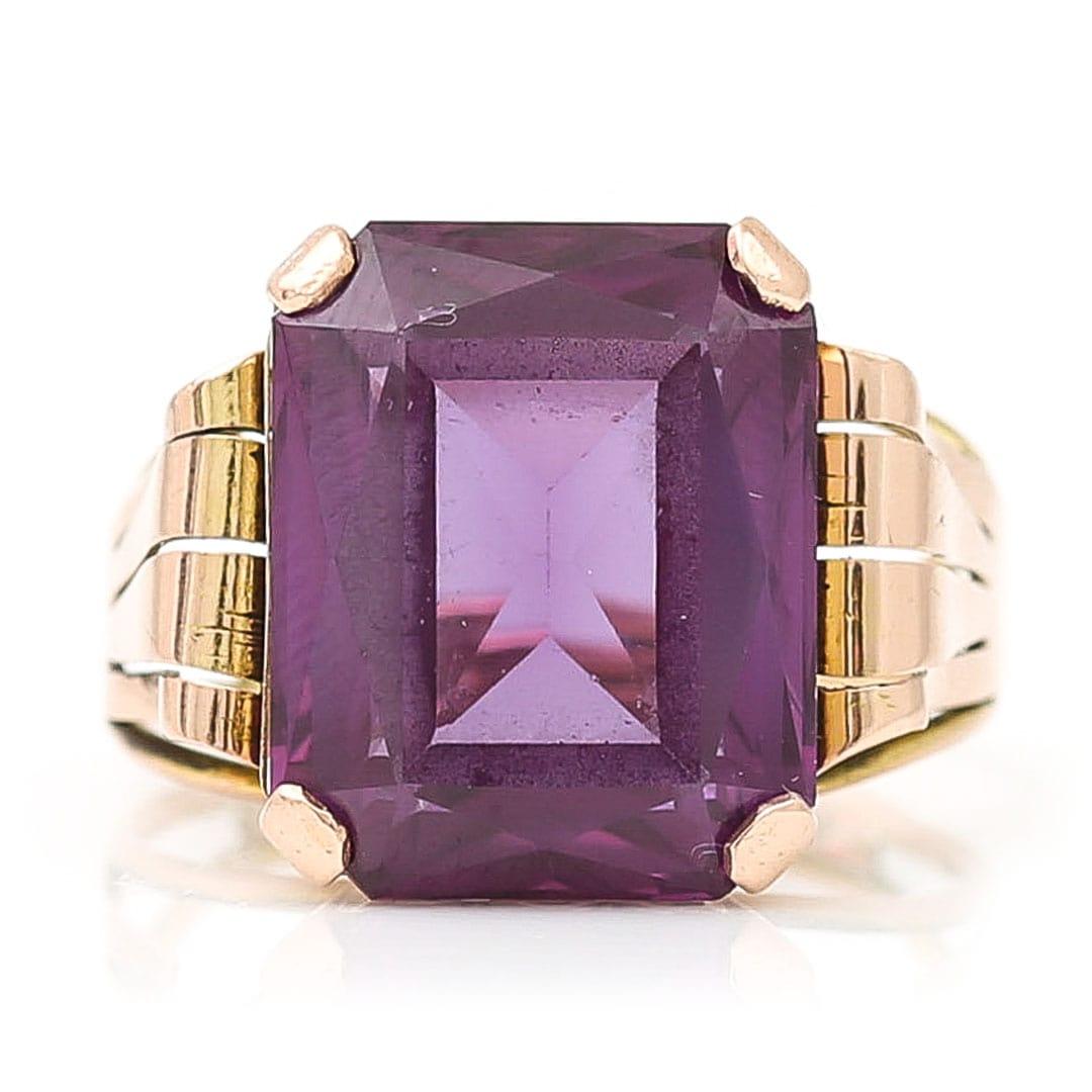 A super stylish, large emerald cut purple, synthetic colour-change sapphire singles tone ring dating from circa 1960.  Synthetic color-change sapphires are fascinating because their strong color-change effect caused by high levels of vanadium