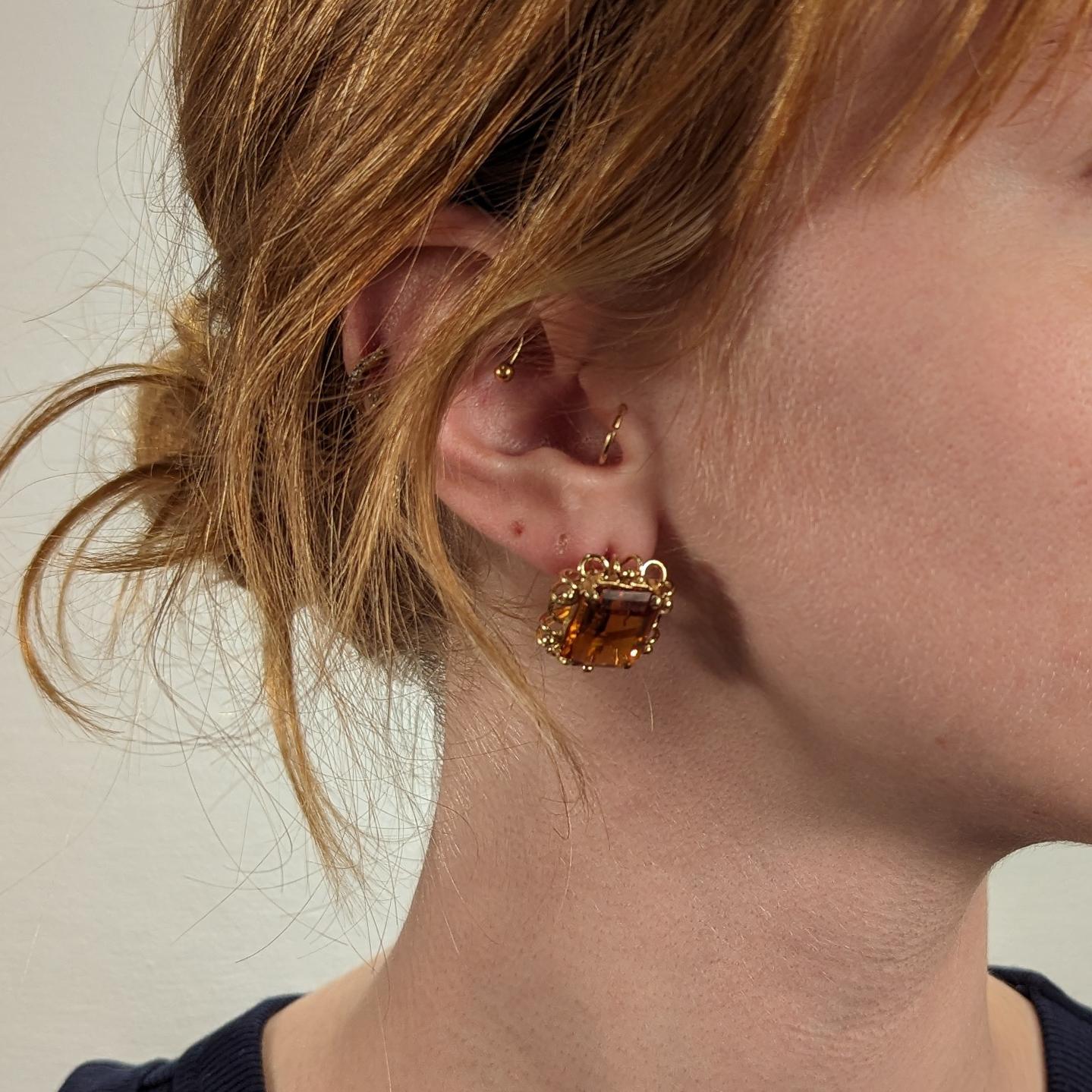 A fine pair of Mid-Century gold & gemstone earrings.

In 14k gold.

With wirework settings and prong-set emerald-cut Madeira citrine gemstones.

Set with omega clips for added security.

Simply a wonderful pair of Mid-Century