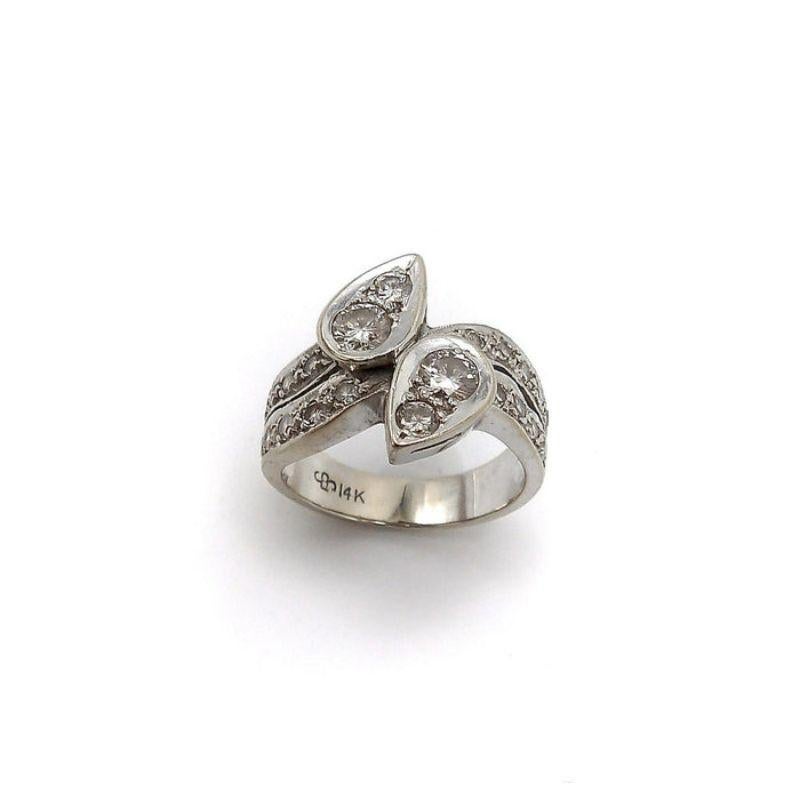 This is a stunning Mid-Century bypass ring by New York Jeweler David Sarkin. Also know as a Moi et Toi ring romantically named for you and me.

The two pear-shaped mounts intersect like a modified yin and yang symbol.  Inside each mount are two 4mm
