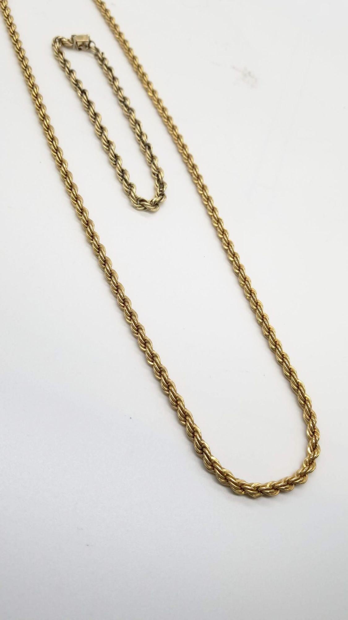 This vintage 14k Gold Rope Chain Necklace and Bracelet set exudes refined beauty and sophistication. The necklace, measuring a graceful 30 inches in length and boasting a width of 2.30mm, showcases the richness of 14k gold in its lustrous finish. It