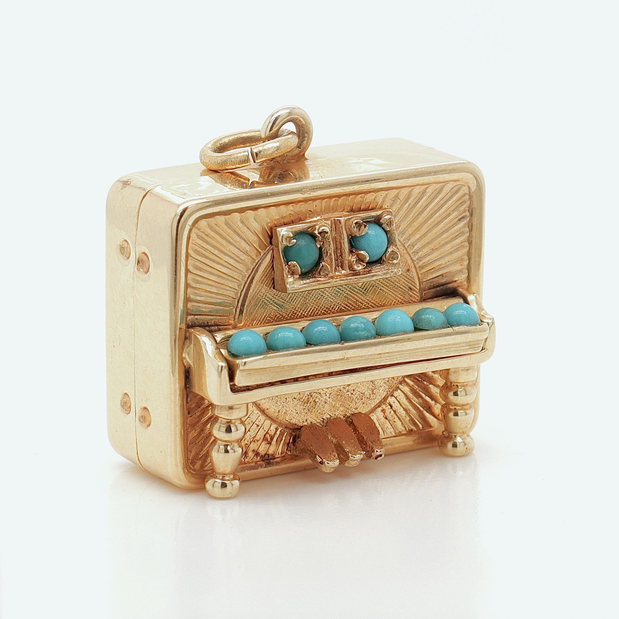 A fine musical charm for a bracelet.

In 14k gold with turquoise cabochons.

In the form of a piano (or player piano).

With an articulating key cover and a fixed bail to the top.

Likely made by Walter Lampl for Marchal Jewelers.

Together with its
