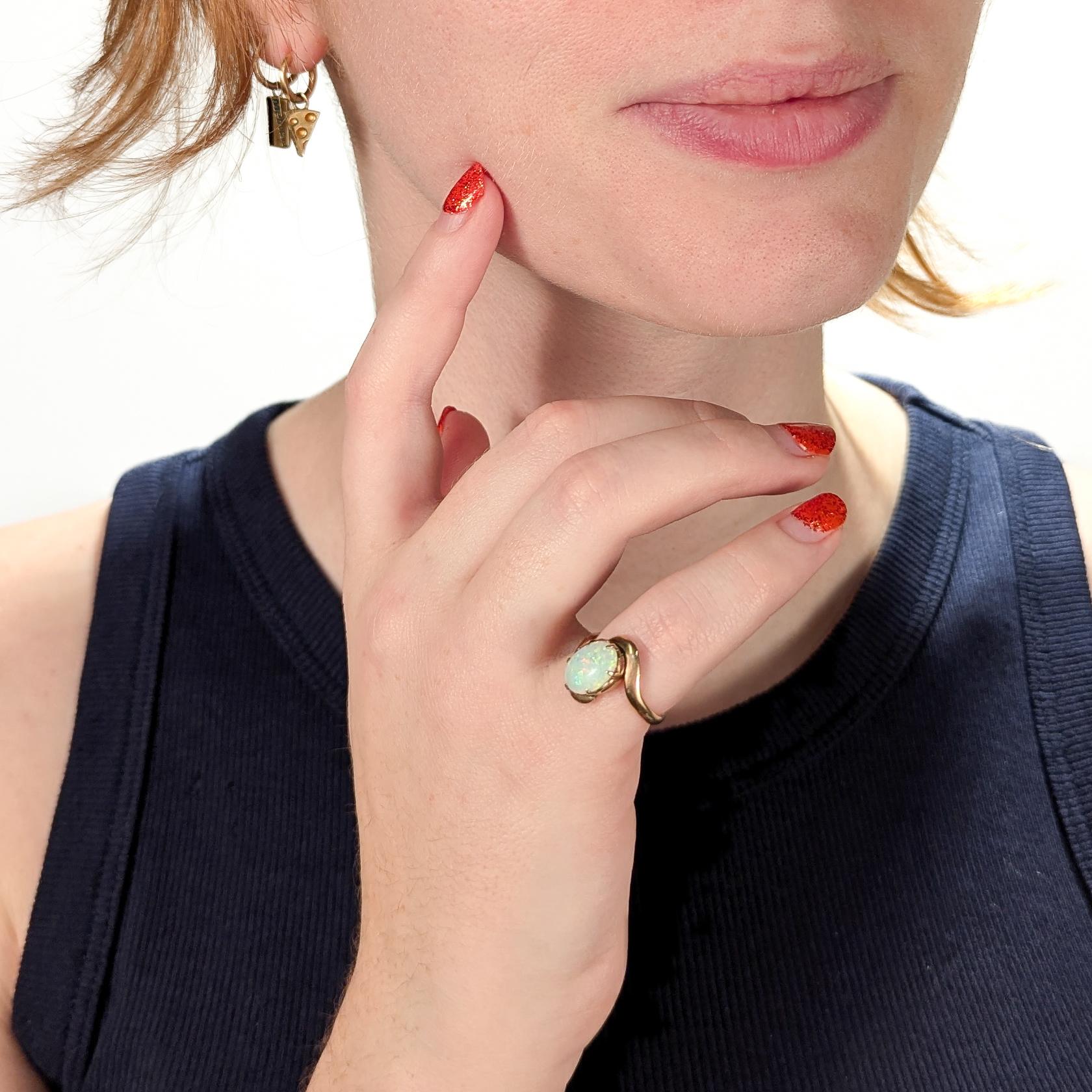 A fine opal cocktail ring.

In 14k rose-tinted gold.

Prong set with an oval opal cabochon centered in a bypass shank.

Simply a wonderful vintage opal ring!

Date:
20th Century

Overall Condition:
It is in overall good, as-pictured, used estate
