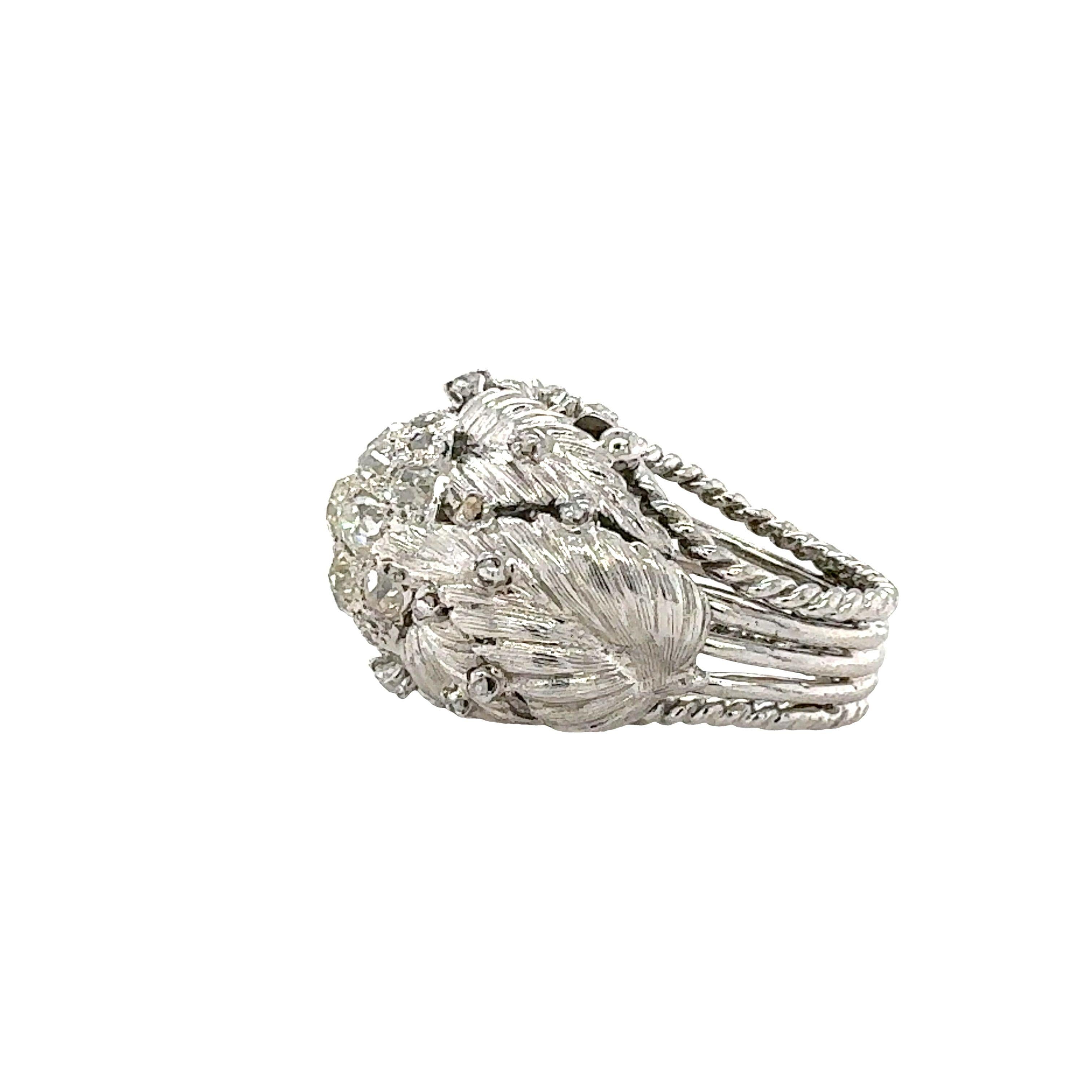 One mid-century diamond cluster, leaf and floral motif designer ring in 14K white gold featuring 39 old mine cut and rose cut diamonds totaling 1.42 ct. with J-K color and VS-2 clarity. 20 millimeters wide at top portion (north to south)

Metal: 14K