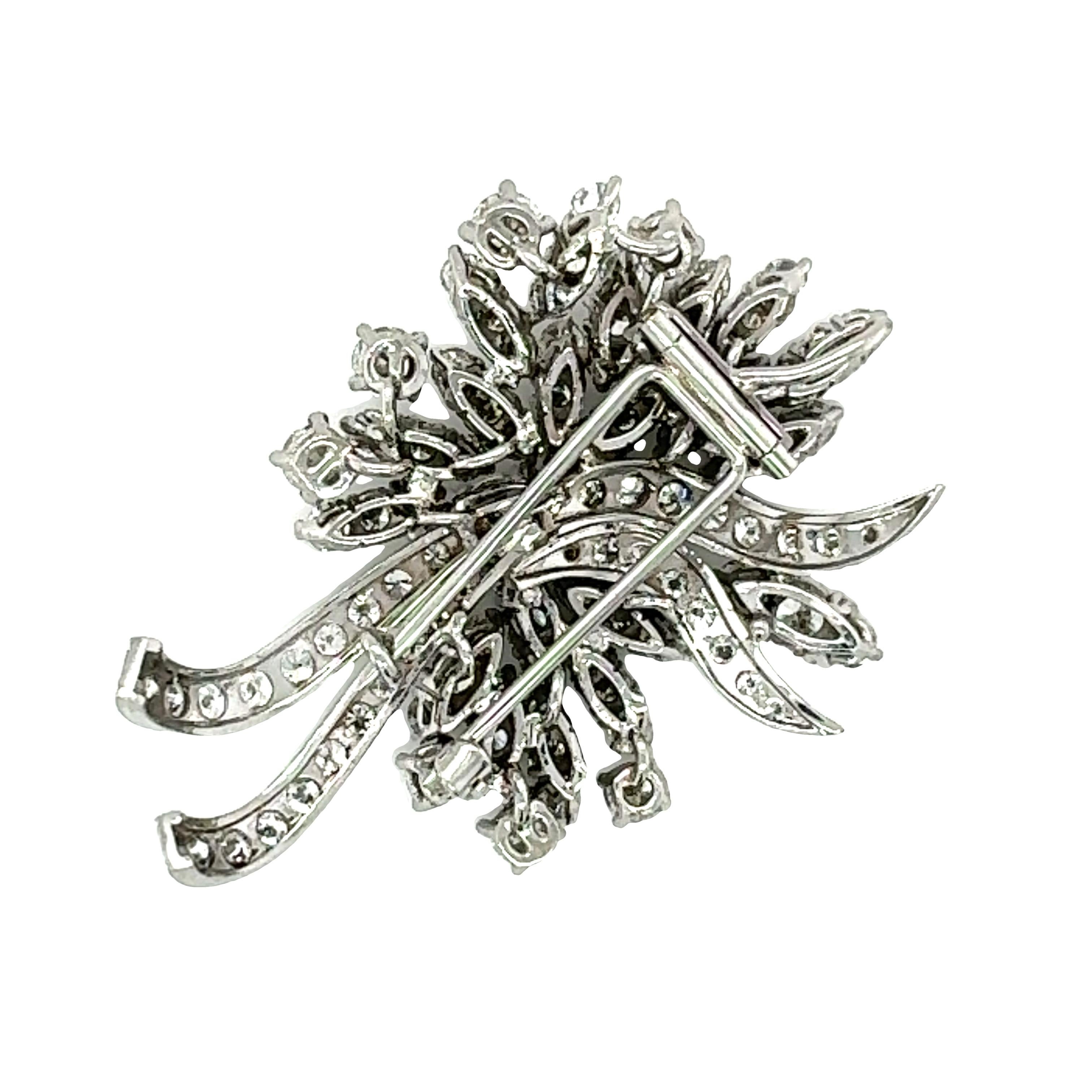 One mid-century diamond floral motif brooch in 14K white gold featuring 106 round brilliant cut diamonds totaling 10.33 ct. with F-G color and VS-1 clarity.

Metal: 14K White Gold
Gemstone: Diamonds totaling 10.33 ct., F-G / VS-1
Circa: