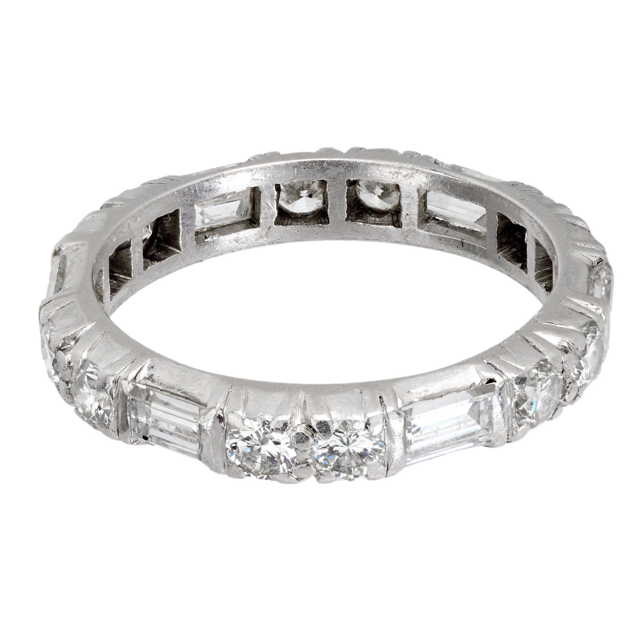 Crafted in the 1950s, this Mid Century platinum ring features a striking blend of 6 baguette cut diamonds totaling approximately .75 carats and 12 round brilliant cut diamonds totaling approximately .85 carats. Graded H-I color and VS clarity