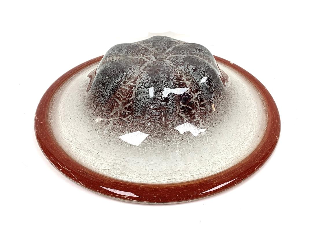 German Art Glass bowl in red, white, and burgundy by By Metallwarenfabrik Württembergische Ikora, ca. 1930s. The bowl with a red border, silvery inclusions, contoured base. Attributed to Karl Wiedmann for WMF, Germany.

Dimensions: 17