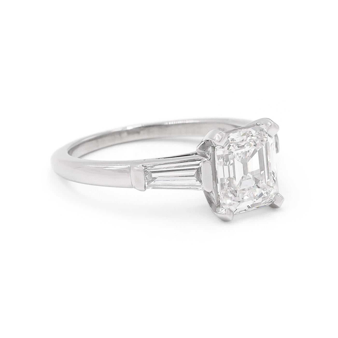 American Mid-Century 1.71 Carat Emerald Cut Diamond Engagement Ring by Tiffany & Co., composed of platinum. With a 1.71 carat Emerald Cut diamond, GIA certified G color & VS1 clarity. With an additional 2 Tapered Baguette Cut diamonds set into the