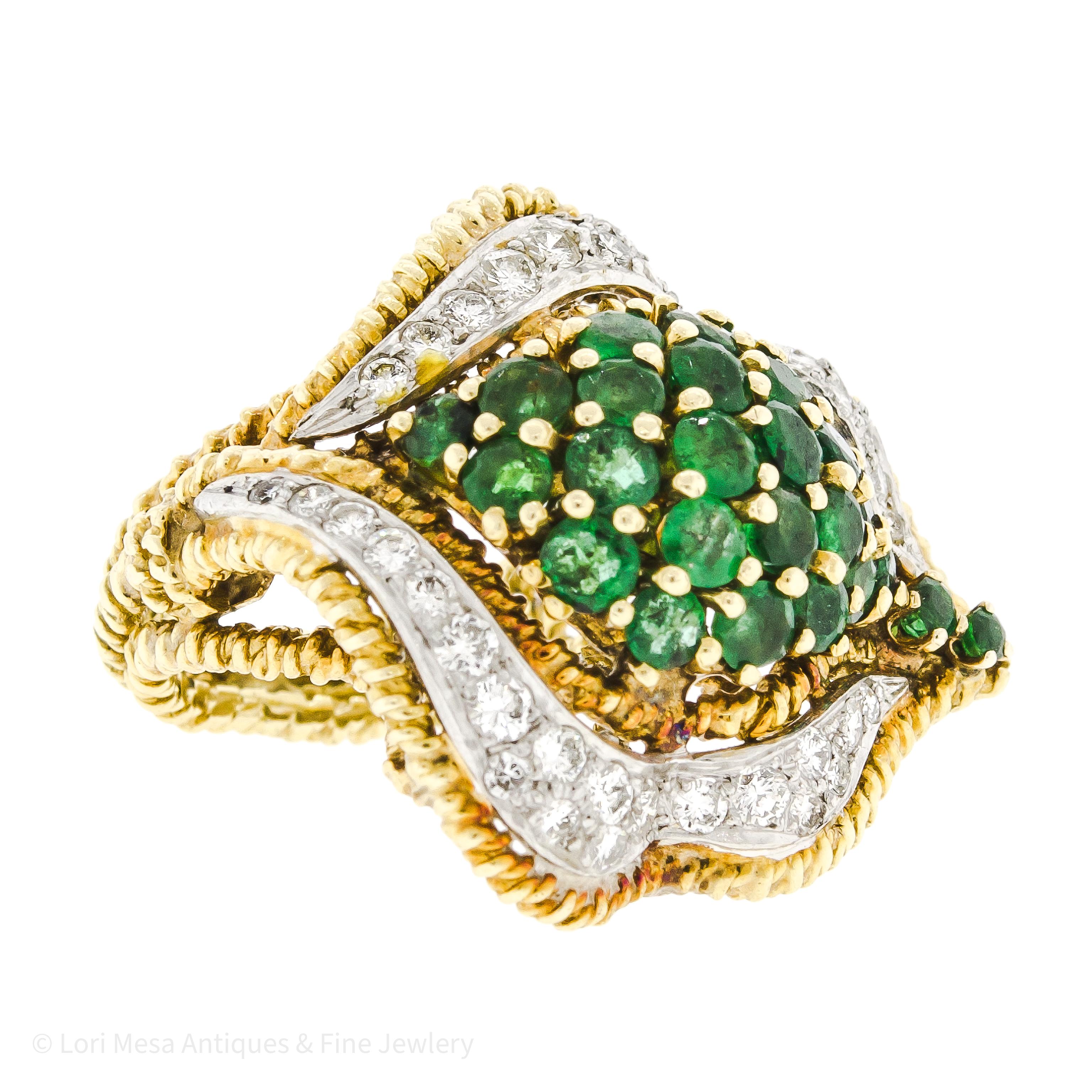 This extraordinary Mid-Century ring is a stunning piece of jewelry, boasting the elegance of 18-karat yellow gold and an enchanting combination of emerald and diamonds. Created around 1950, the intricate rope-textured yellow gold wirework setting is