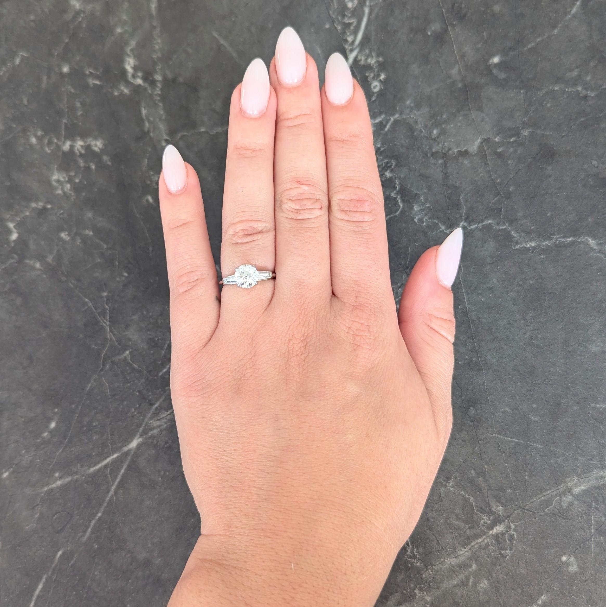 Centering an old European cut diamond weighing 1.39 carats - J color with SI1 clarity
Prong set in a stylized basket and flanked by cathedral shoulder
Each bar set with tapered baguette cut diamonds
Weighing approximately 0.42 carat
H/I color with