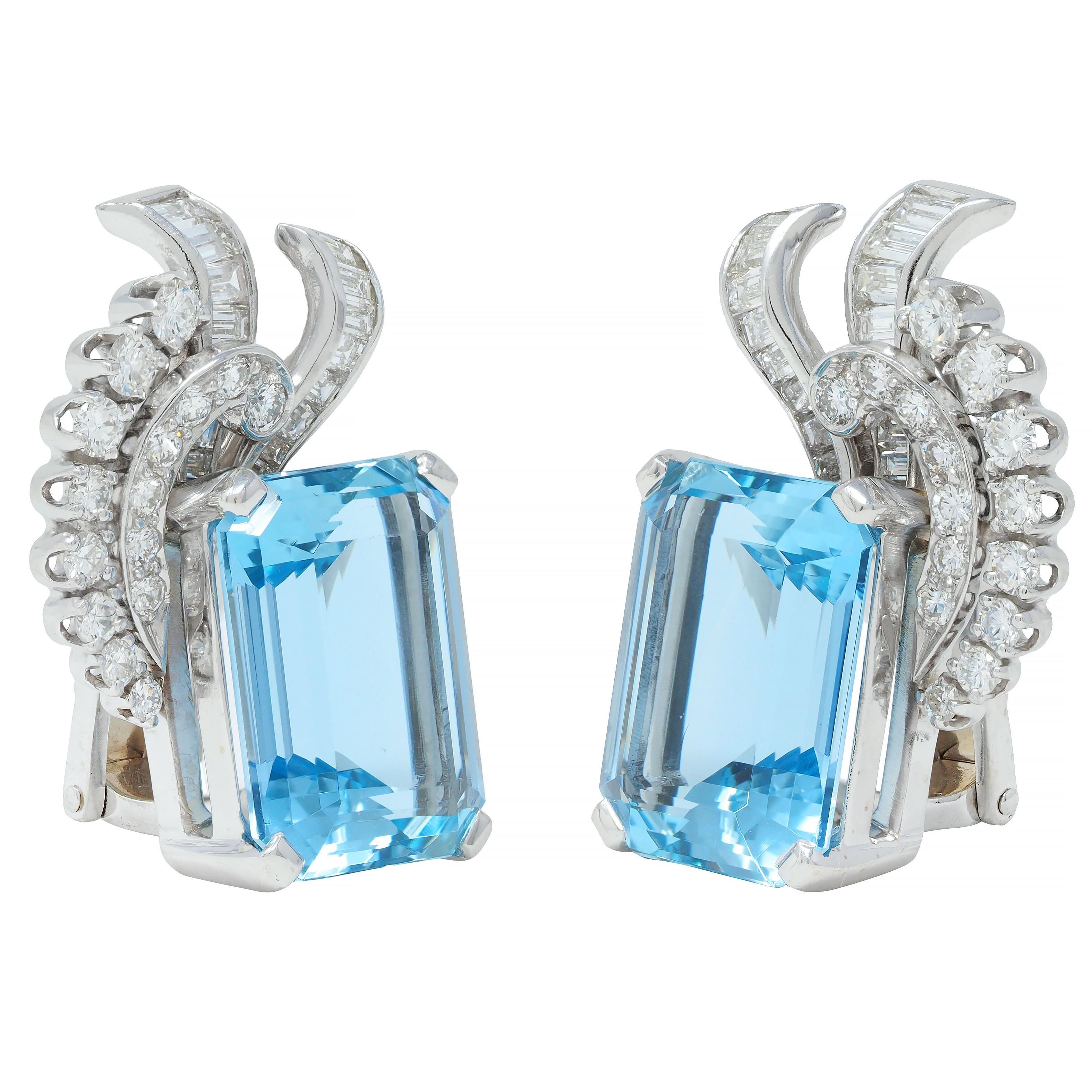Featuring emerald-cut aquamarines weighing approximately 17.20 carats total 
Transparent light blue in color and prong set in a white gold baskets
Juxtaposed by scrolling rows of round brilliant and baguette cut diamonds
Weighing approximately 1.24