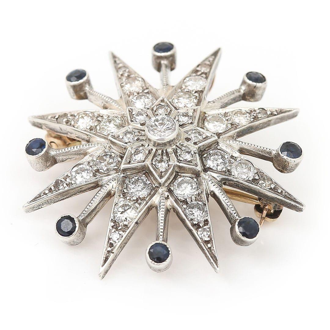 A stunning 1960’s brilliant cut diamond star ‘sunburst’ brooch dating from around 1960 comprising of approx 1.80ct of diamonds and 0.60ct of blue sapphires. This fabulous brooch, measuring 36mm in diameter is set in 18ct gold with a silver front, in
