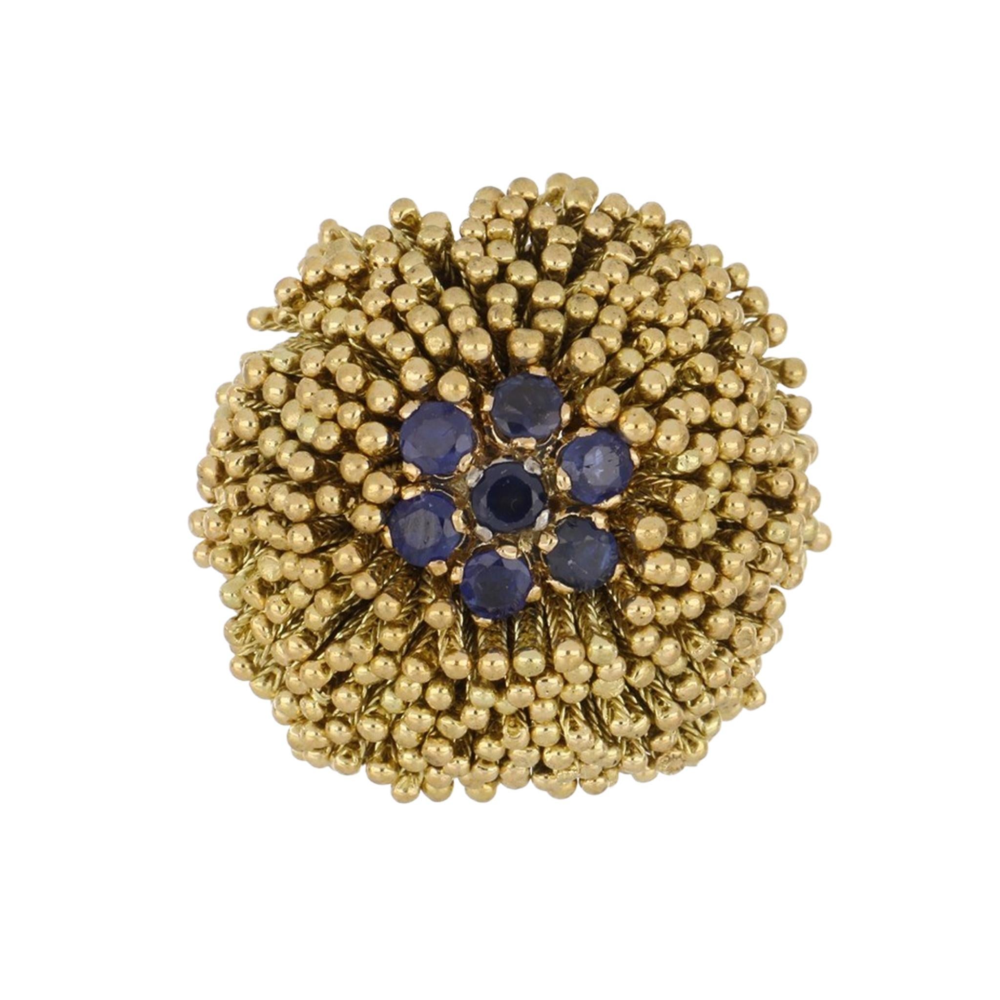 An estate antique, Mid-Century pom-pom ring with foxtail chain details and a center cluster of round sapphires, set in 18k yellow gold.  Circa 1950. The center cluster of 7 round sapphires total 1.05 total carat weight. The ring is currently a size