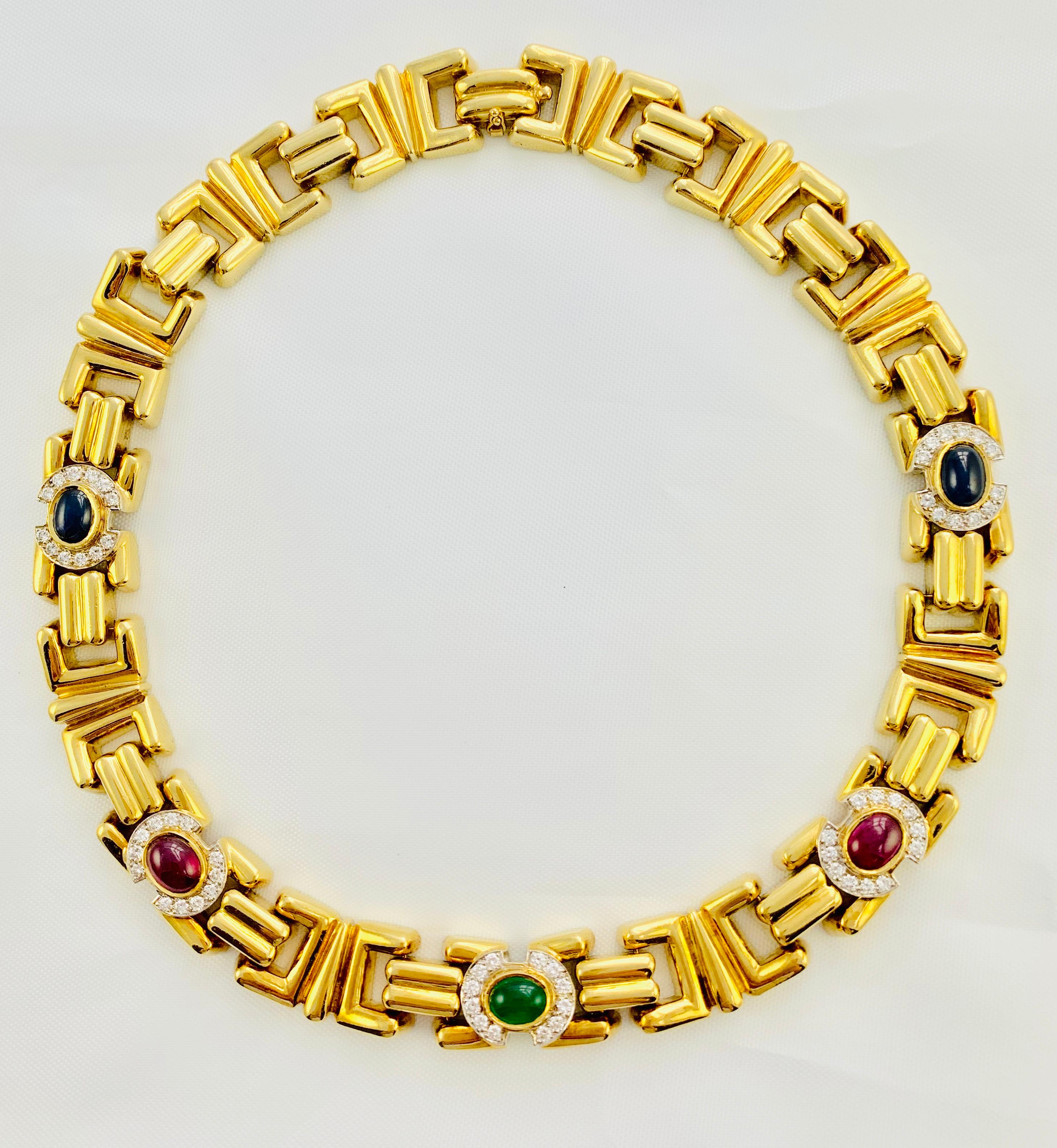 This very important 18K yellow Gold Suite Consists of a 16 inch, repeating link, choker necklace that is set with two 8 by 6mm cabochon cut sapphires, two 8 by 6mm cabochon cut rubies and one 8 by 6mm cabochon cut emerald! These gorgeous stones are