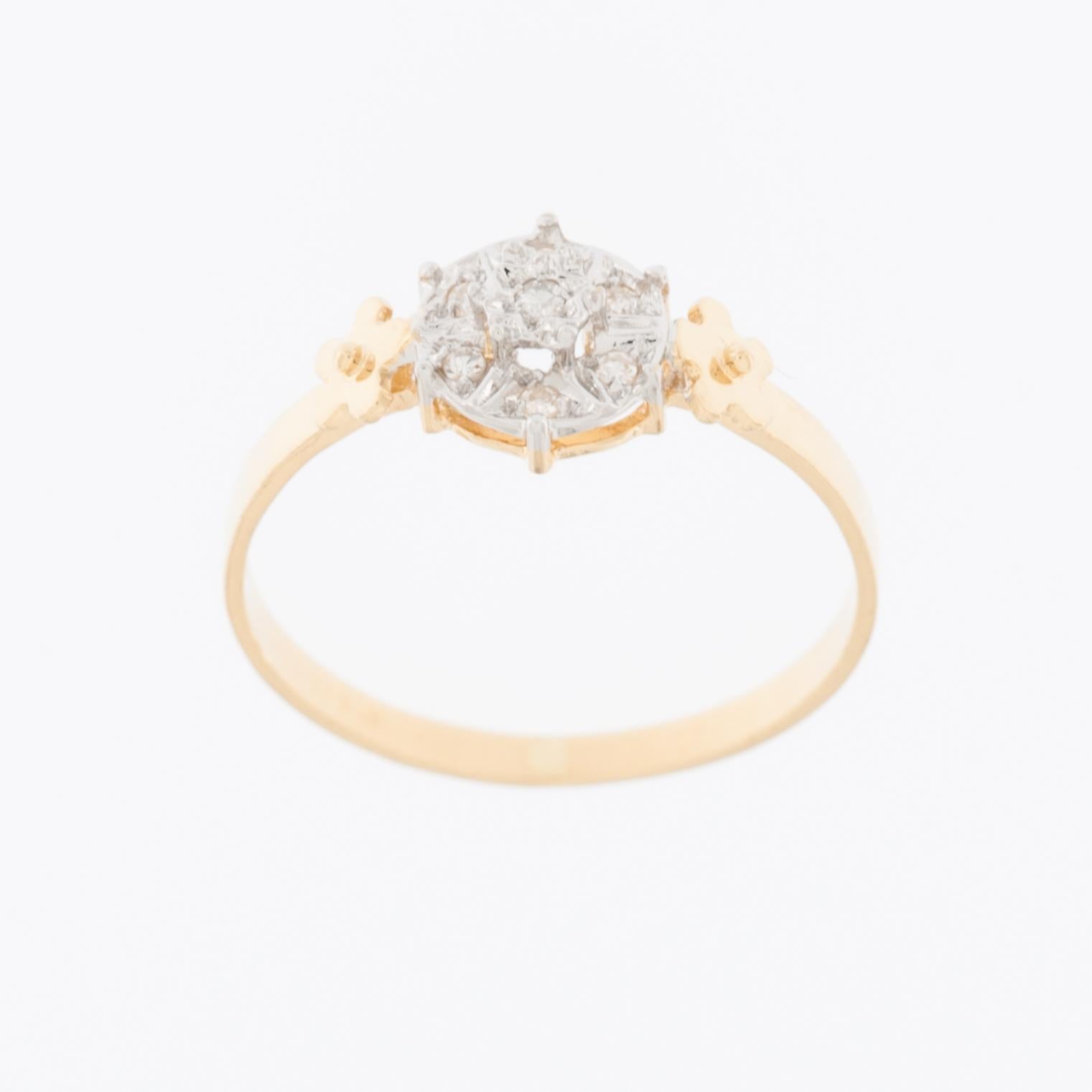 The Mid-Century 18kt Yellow and White Gold Ring with Diamonds is a beautiful and classic piece of jewelry. 

The ring is made from 18 karat yellow gold. Karat (kt) is a measure of the purity of gold, and 18kt gold is 75% pure gold, with the