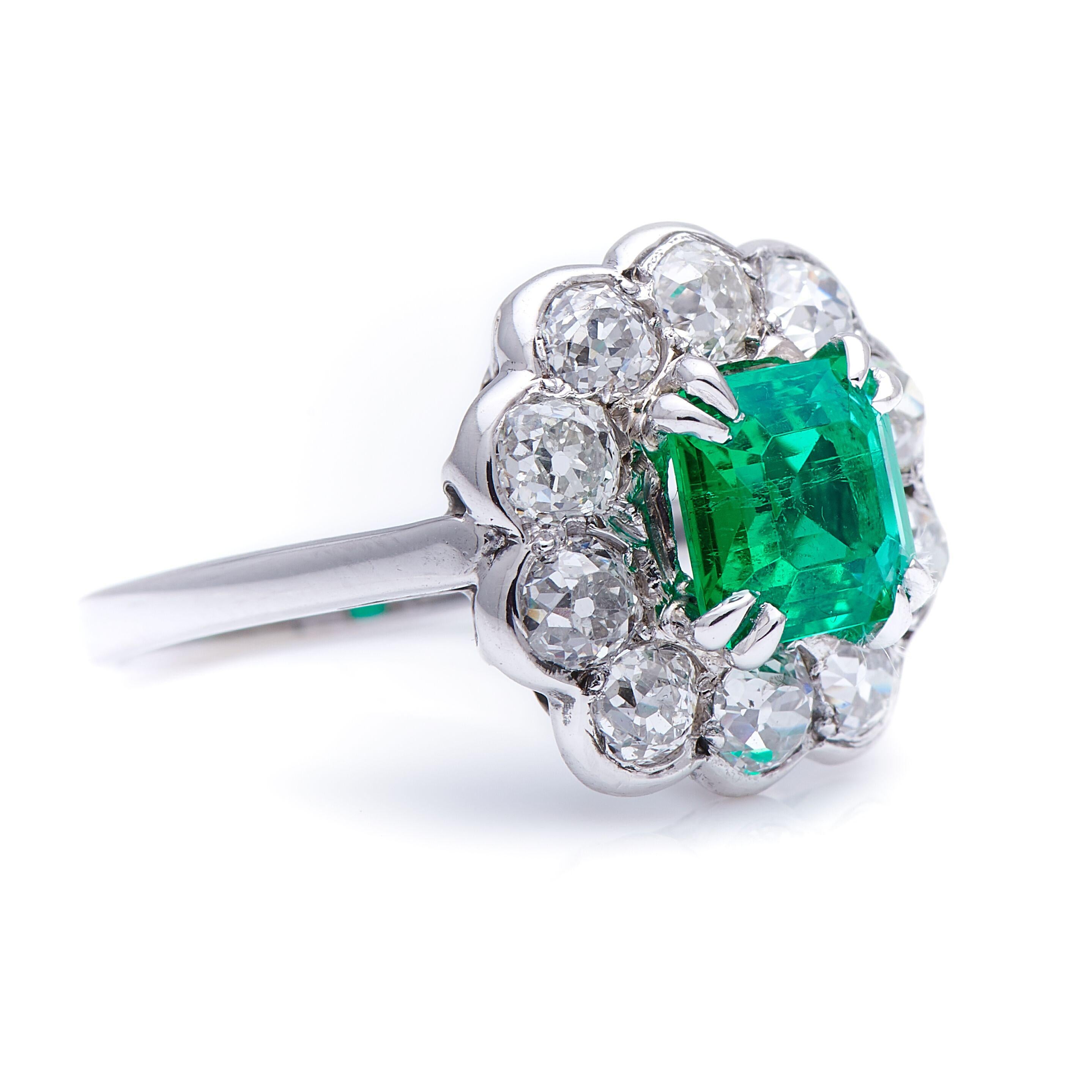Emerald and diamond ring, circa 1940. This classic floral cluster centres on an excellent Colombian emerald weighing approximately 1.1 carats. Its vibrant, fresh green tone is bettered only by a superb and rare level of clarity for an emerald, with