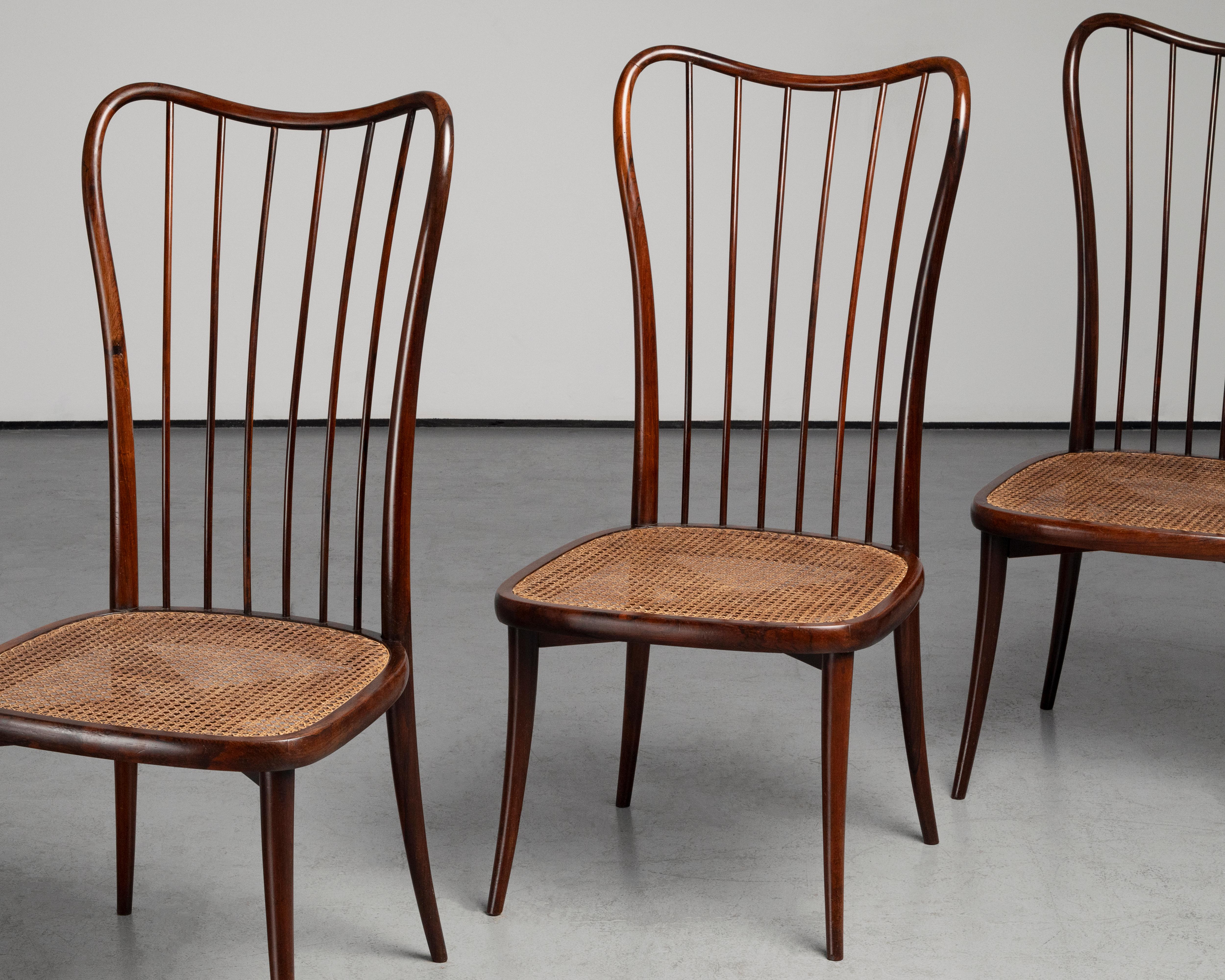 This set of four chairs, designed by Joaquim Tenreiro in 1948, is a refined example of Brazilian modernist furniture. Crafted in peroba wood with woven straw seats, the chairs reflect Tenreiro’s commitment to lightness, elegance, and the honest use
