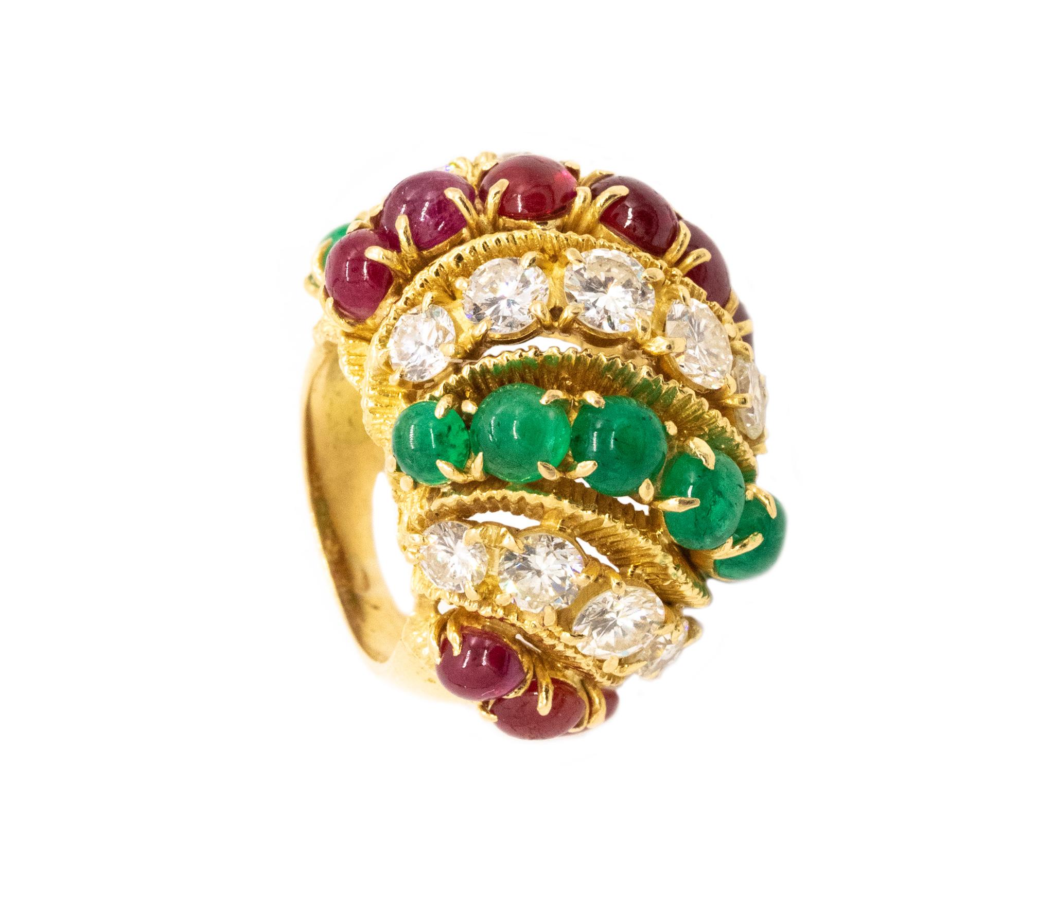 Oversized jeweled Tutti-Frutti cocktail ring.

A mid-century Hollywood regency bombe ring made in America after the war, circa 1950's. It was crafted in solid 18 karats of textured yellow gold.

The entire dome is mounted with natural gemstones,