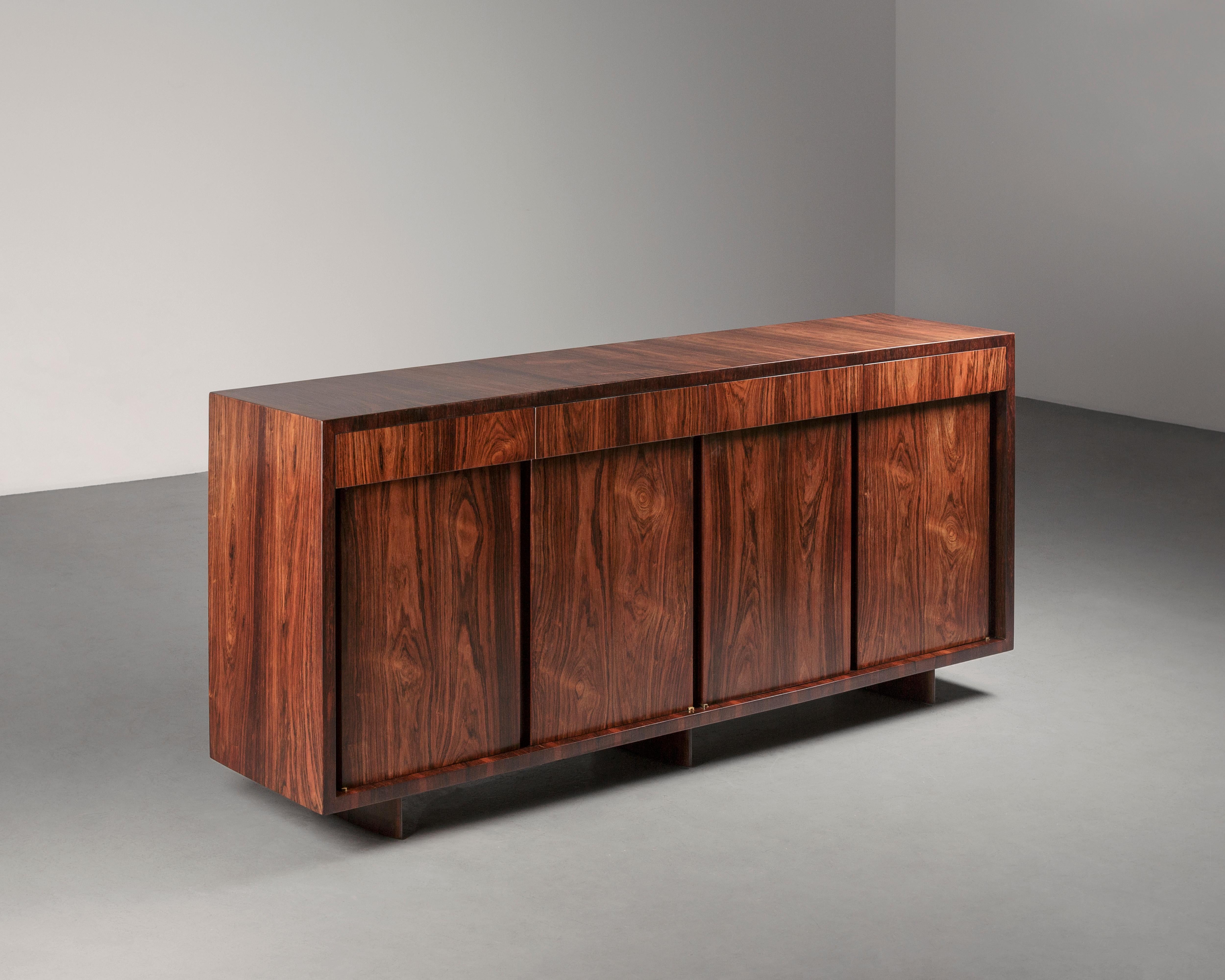 The Small Credenza is an elegant four-door buffet, featuring four drawers in a minimal and symmetrical design. The buffet is entirely crafted from imbuia wood, a luxurious yet durable material that enables an everyday use of the
furniture. The