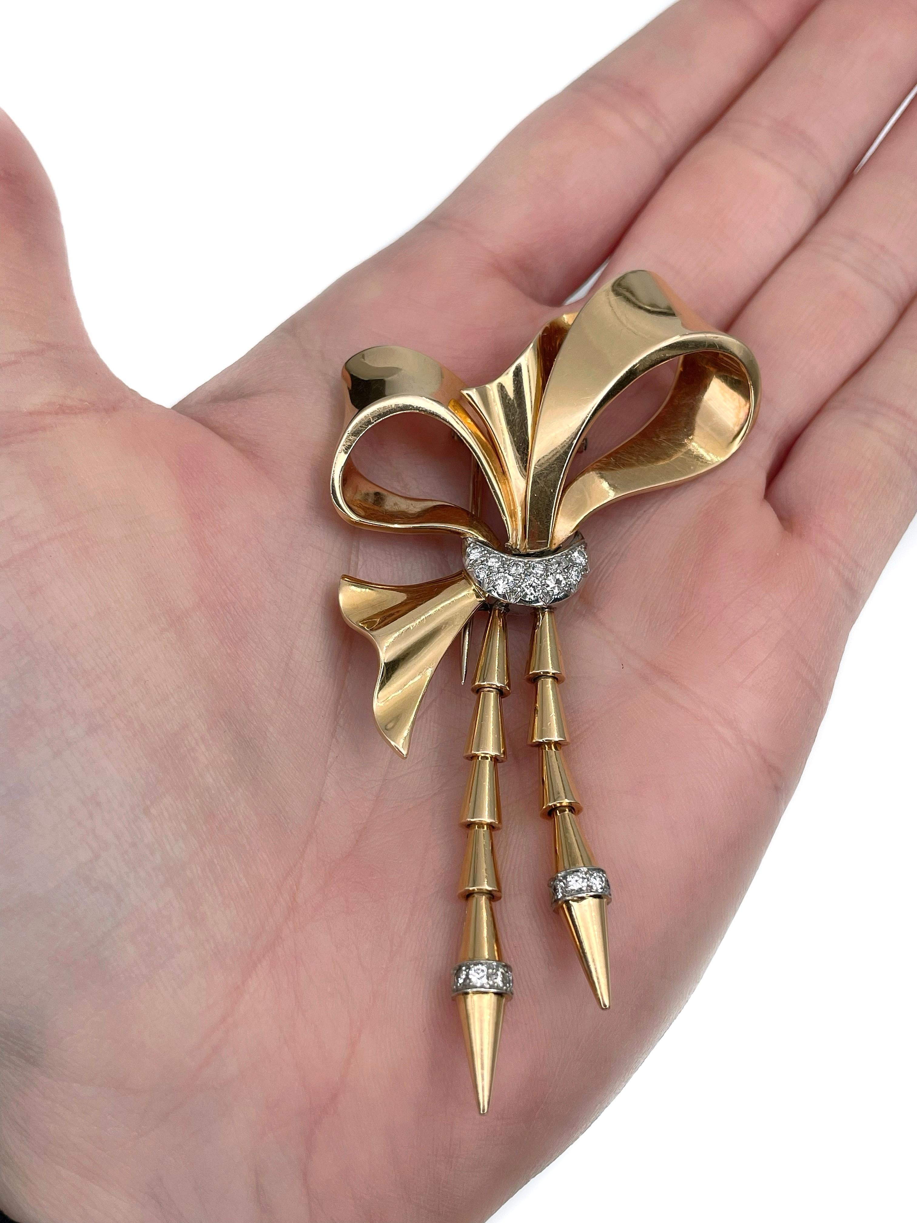 This is an elegant bow shape pin brooch crafted in 18K yellow gold and adorned with PT900. Circa 1950. 

The piece features 19 diamonds: round brilliant cut, TW 0.35ct, RW-W, SI. 

Has a safe clasp. 

Weight: 21.19g
Length: 8.5cm
Width (at max):