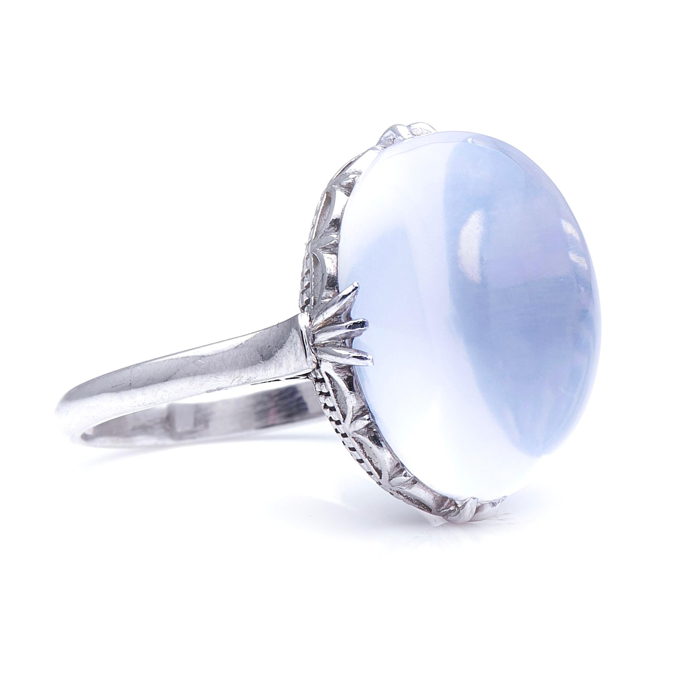 Moonstone ring, 20thcentury. This large moonstone cabochon, weighing approximately 12 carats, is unusual for its pure white colour, it which gives it a uniquely mystic, diaphanous appeal – a rather beautiful ethereal sheen.  Claw-set within a