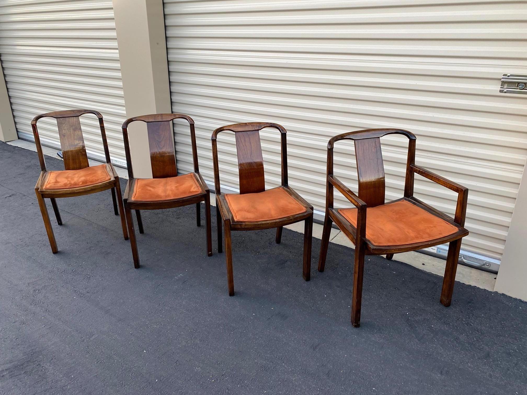 Beautiful set of 4 Baker Furniture Co. Mid-Century Modern dining chairs. These gorgeous chairs have clean and modern lines. With Minor wear consistent with age. One captains chair along with 3 armless chairs. Beautiful vibrant orange velvet seats.