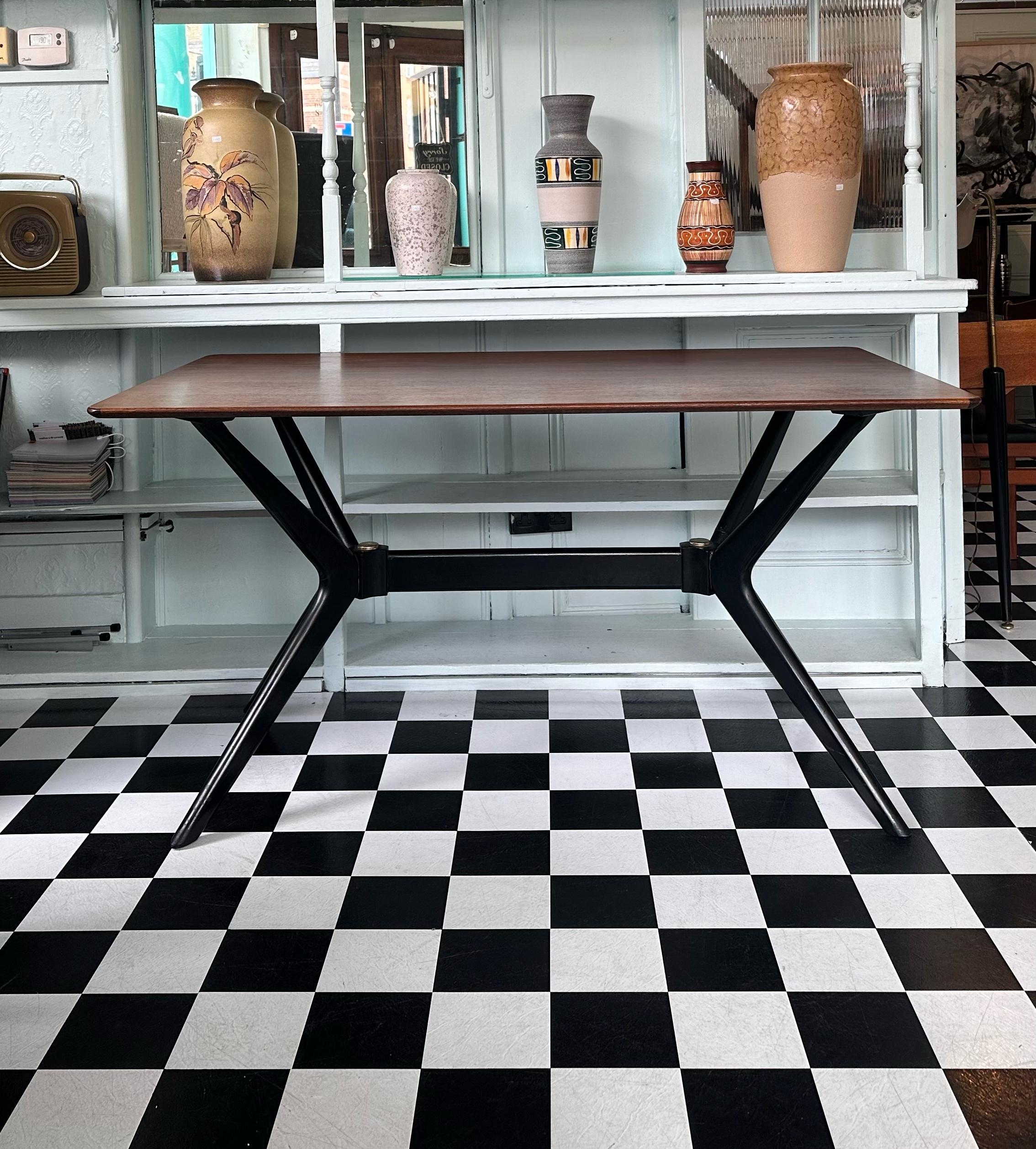 Very rare Mid Century Modern ‘Helicopter’ dining table. Designed in the 1950’s by E Gomme G Plan, part of their Librenza range. Features sleek sophisticated lines, beautiful teak top and solid beech ebonised legs. This table is a true masterpiece
