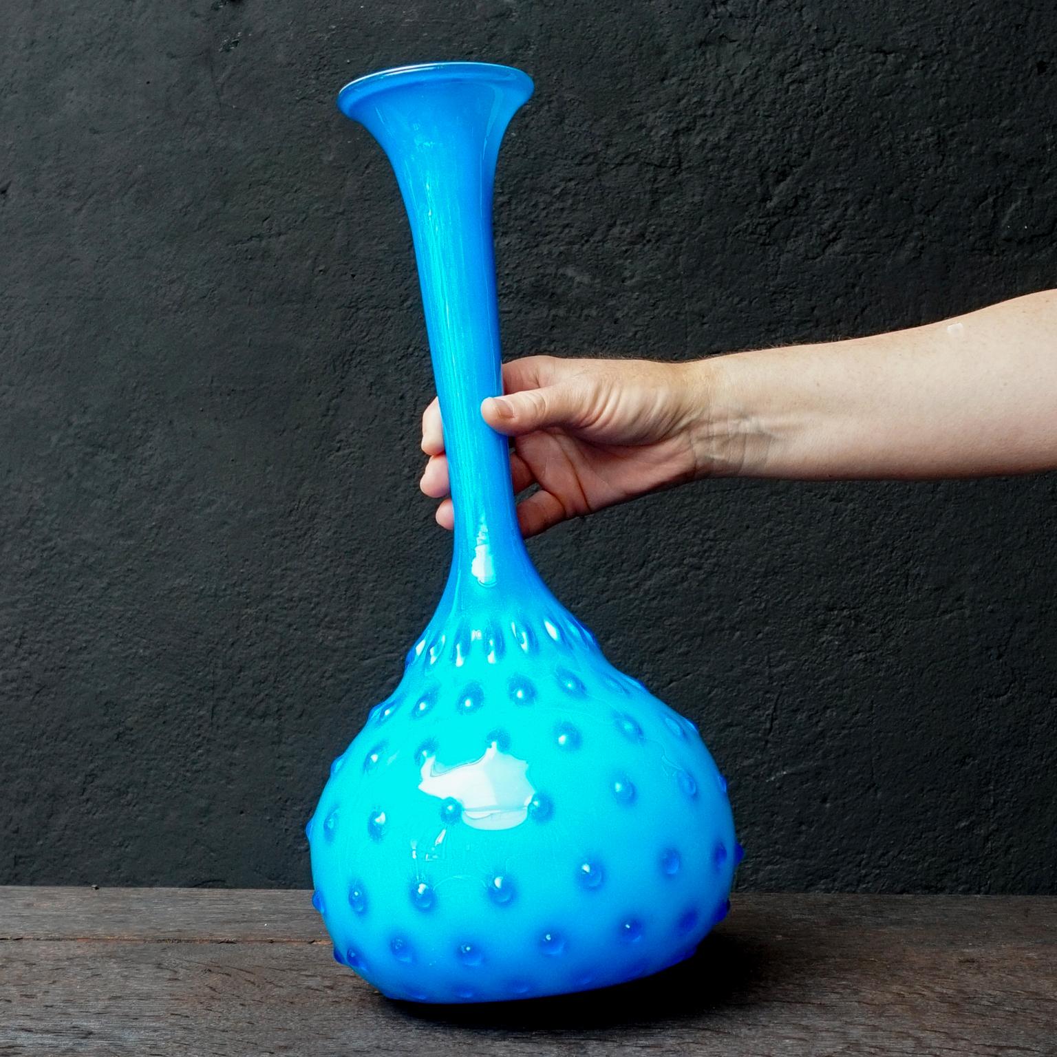 What an eye-catcher this Mid-Century Modern 1950s Italian Empoli bright blue cased art glass vase is.
It is handblown by glass craftsmen in Empoli, Florence, Italy.
During the glass blowing process the hobnail design is applied. 

This large