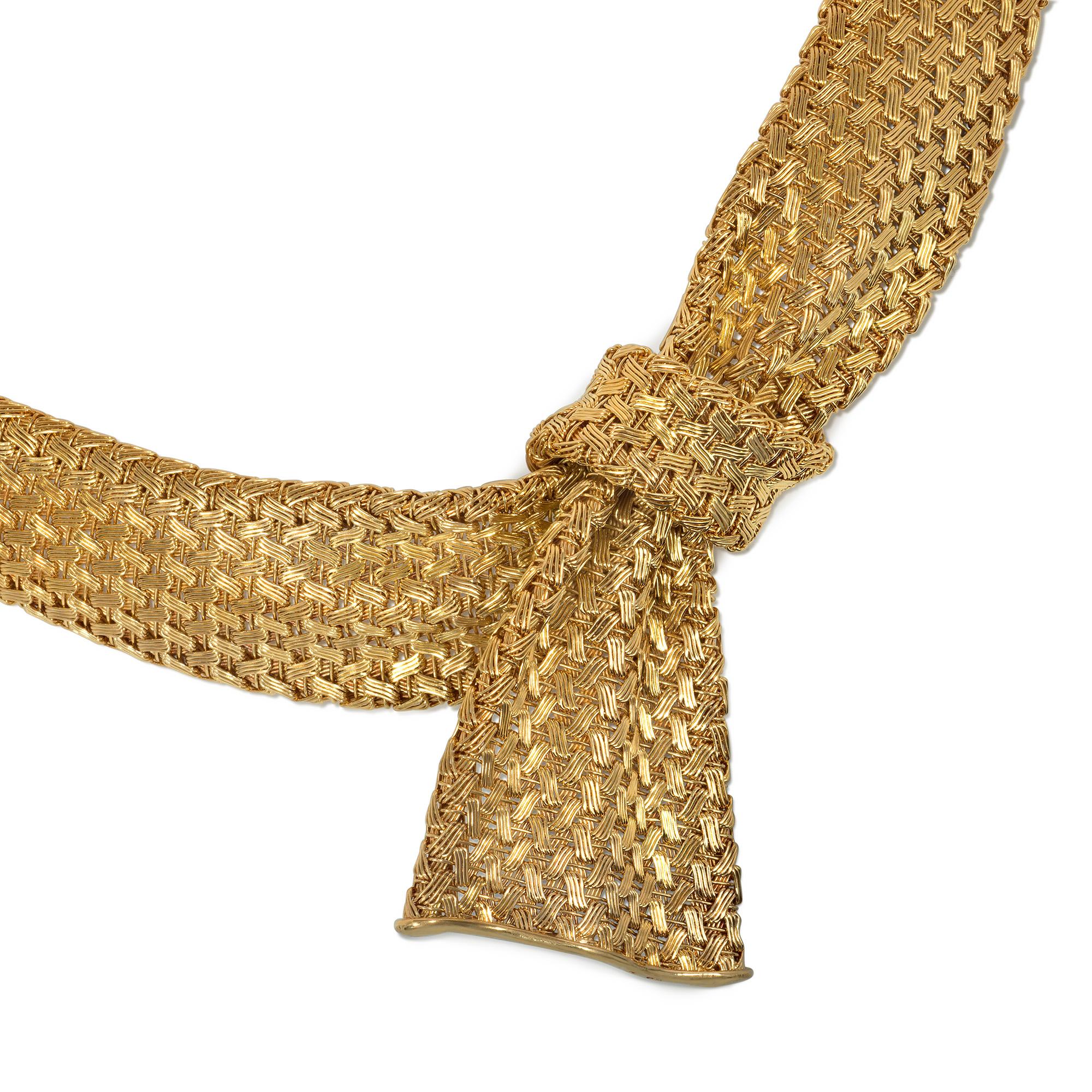 A Mid-Century 1950s flexible gold necklace of tapering, basket-weave design, centered by a knotted ribbon bow, in 18k with figure-8 safety.  Stamped WP.

* Includes letter of authenticity
* Free shipping