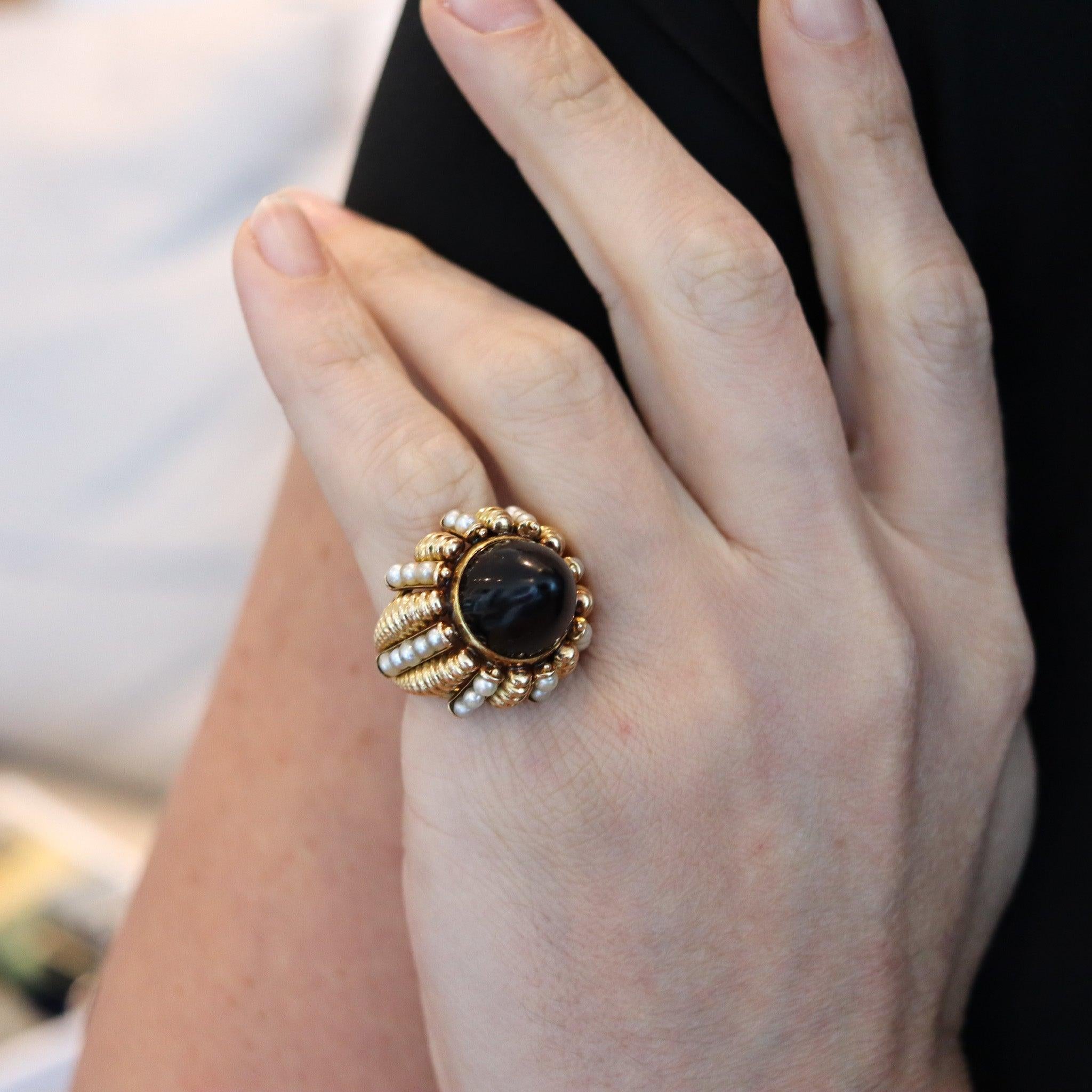 Italian cluster cocktail ring with pearls and onyx.

This is a substantial over sized cocktail ring, created in Italy during the late mid-century period, back in the 1960's. This ring was designed as a domed cluster, carefully crafted in solid