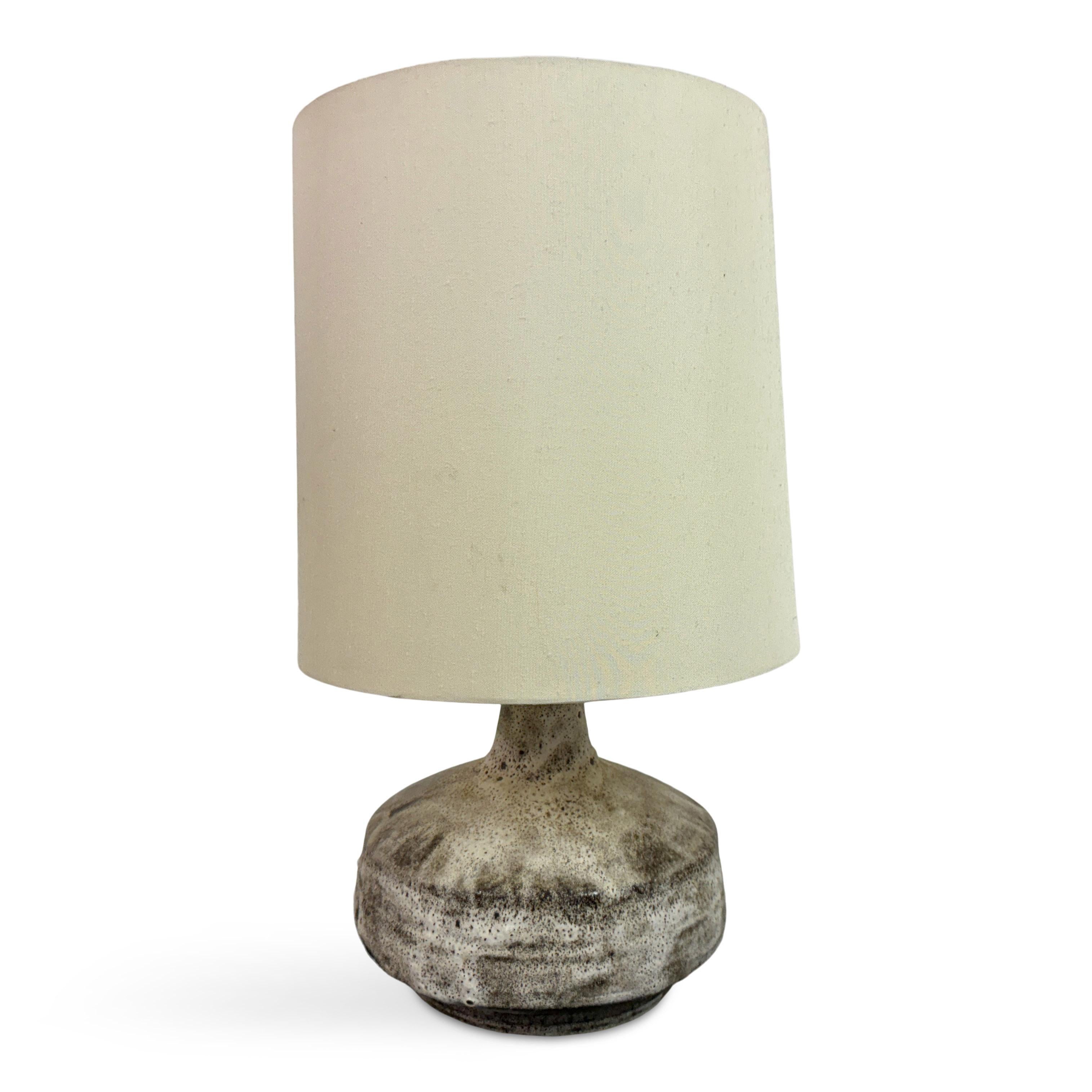 Lampada da tavolo in ceramica degli anni '60

Questa lampada da tavolo in ceramica degli anni '60 incarna un design rustico e moderno tipico dell'arredamento di metà secolo. La base ha una forma arrotondata e organica, con una finitura strutturata e