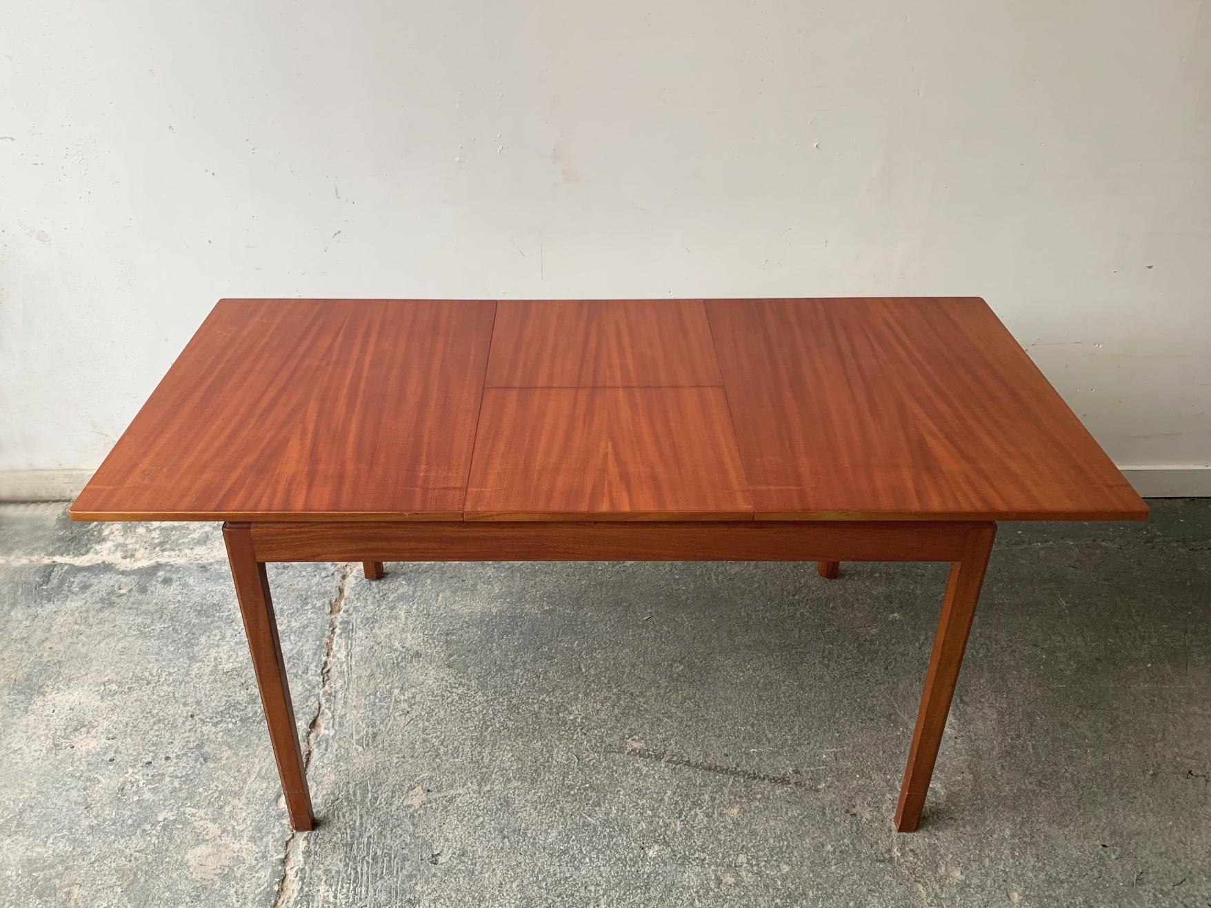 A clean lined minimal Danish style dining table with subtly elevated table top. Produced in the 1960’s by highly respected manufacturer A.H.Mcintosh & co. Ltd. of Kirkcaldy Scotland UK.

4 matching dining chairs available, which are being
