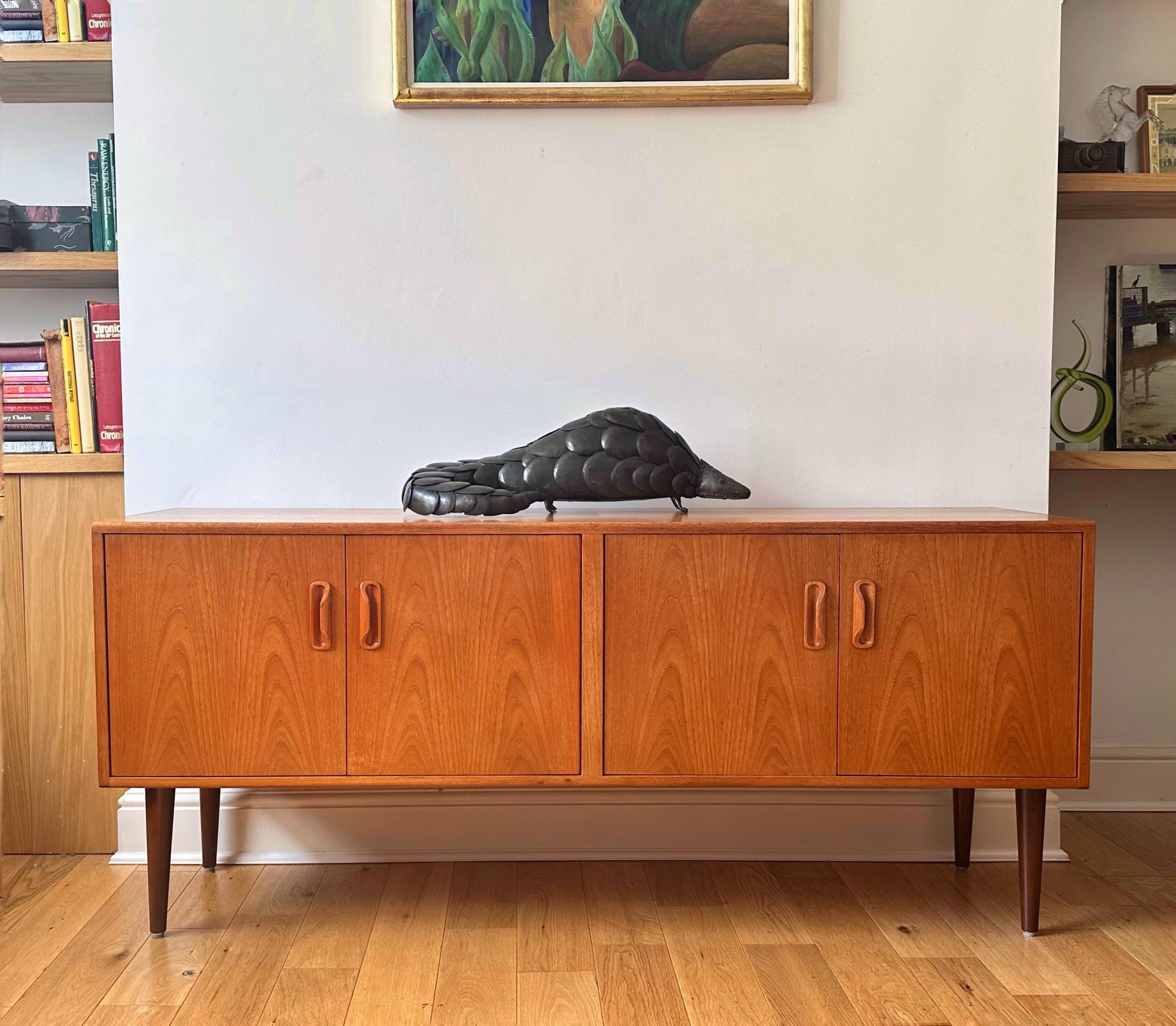 This beautiful sideboard was manufactured by G Plan in the 1960’s. 
Features two spacious cupboards on each side, one with removable/adjustable shelf. 
The sideboard rests on stylish tapered legs. Beautiful golden teak grain throughout - would make