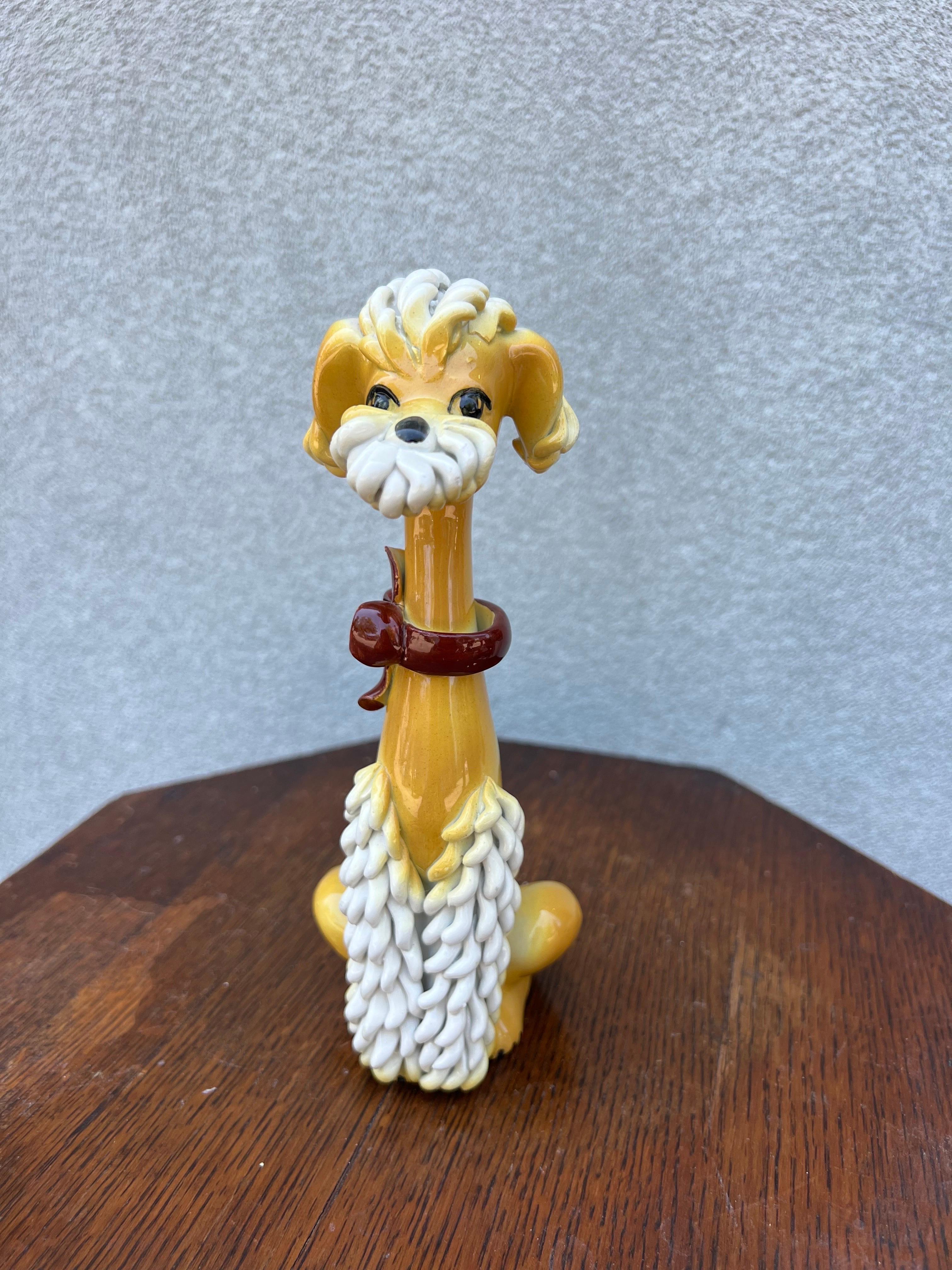 Mid Century 1960s Italian Spaghetti Poodle Dog Anthropomorphic Statue in yellow and White Ceramic.  Signed Italy
Such a whimsical piece, I love the expression on its face.