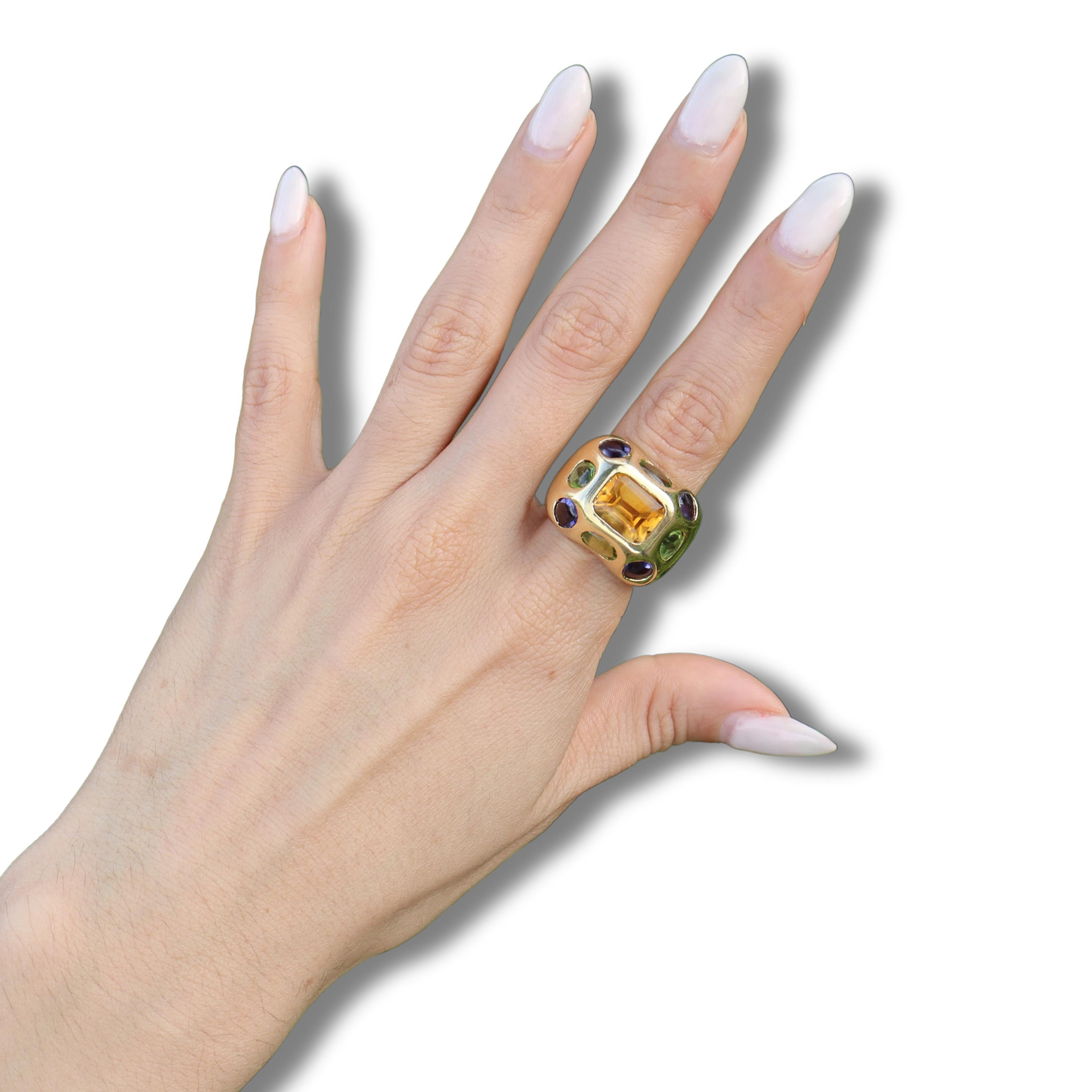 Step back into the vibrant elegance of the 1960s with this stunning mid-century ring, a true testament to the era's bold artistic expression. Expertly crafted in luxurious 18kt yellow gold, this exquisite piece features a striking center emerald cut