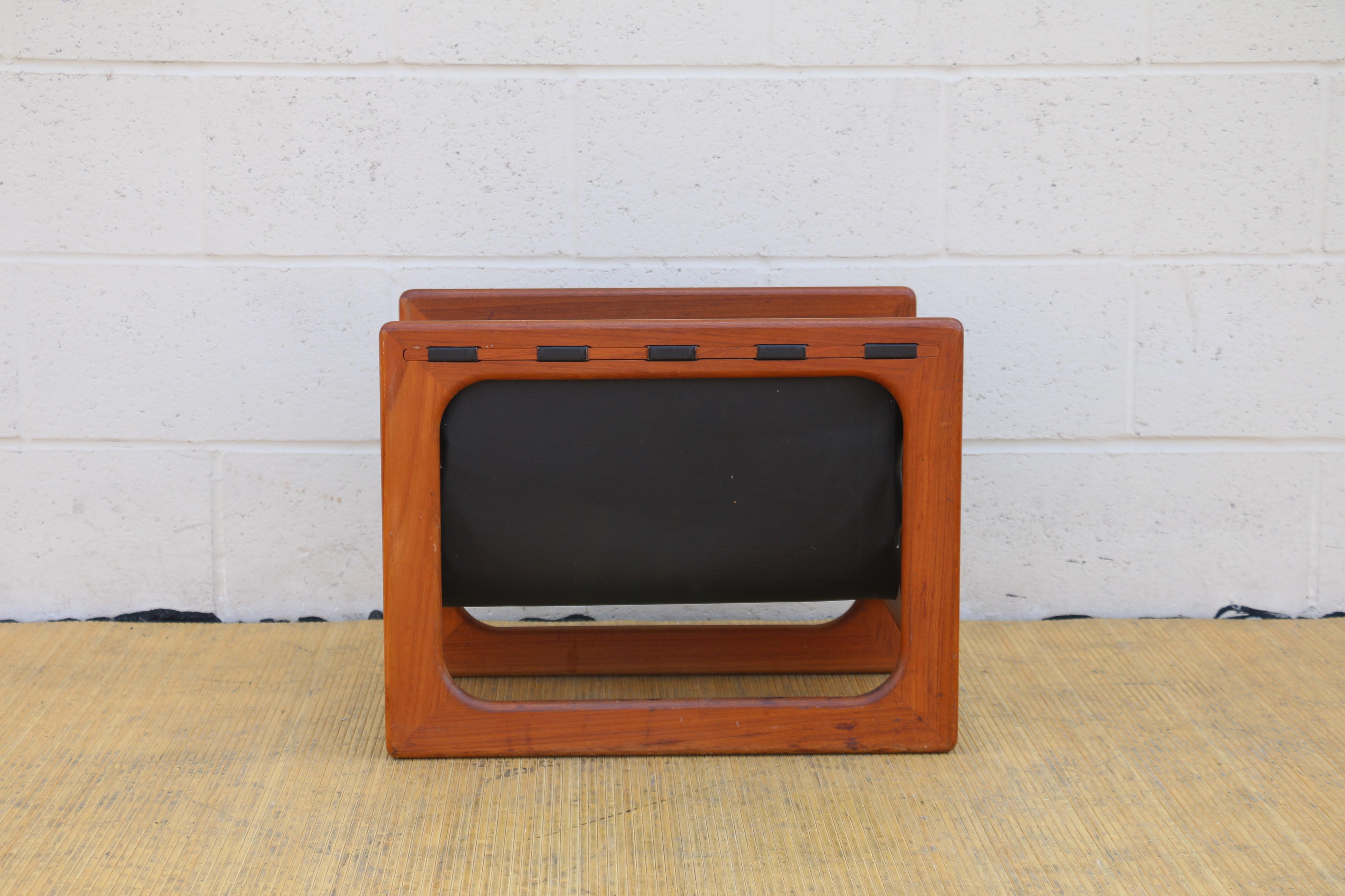 Wonderful magazine rack designed by Aksel Kjersgaard for Salin Mobler, 1970s, Denmark. (It has no label or makers mark however it is well documented in design history). The frame is made of solid teak wood with real leather hanging compartments.
