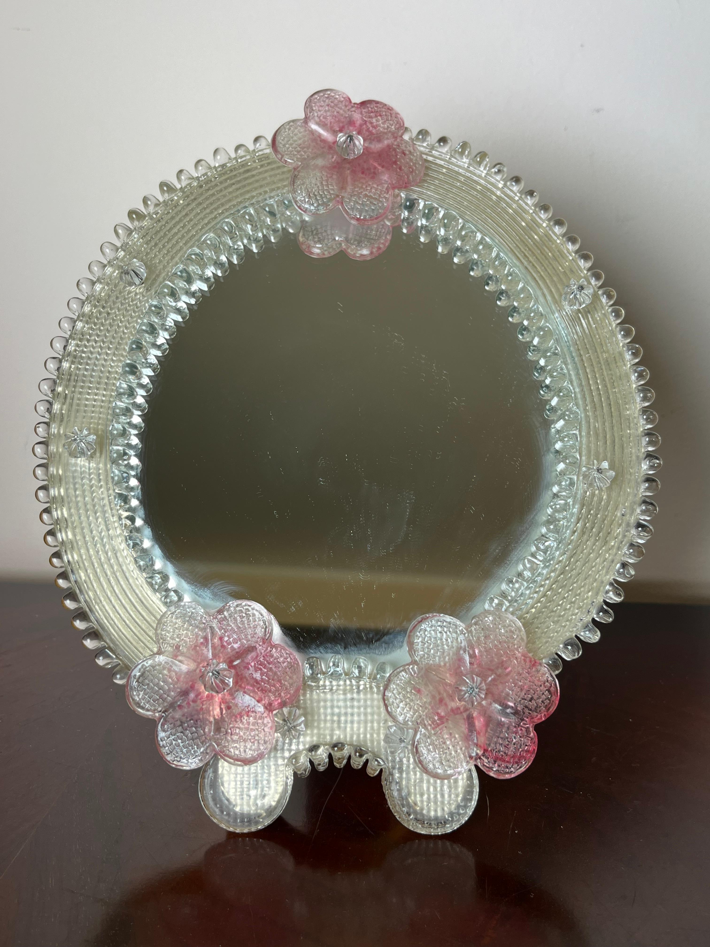 Mid-Century 1970s Venetian Murano glass table mirror
It can be hung. It is intact and in excellent condition.