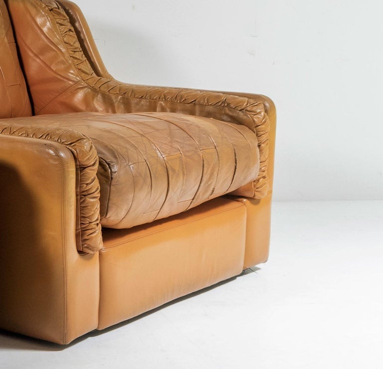A 1970s designer piece by Gimson and Slater, England. Gimson and Slater were a company making high end contemporary sofas and chairs in the 1960s and 1970s. This Tan coloured patchwork leather chair is typical of their unique design of the late 60s