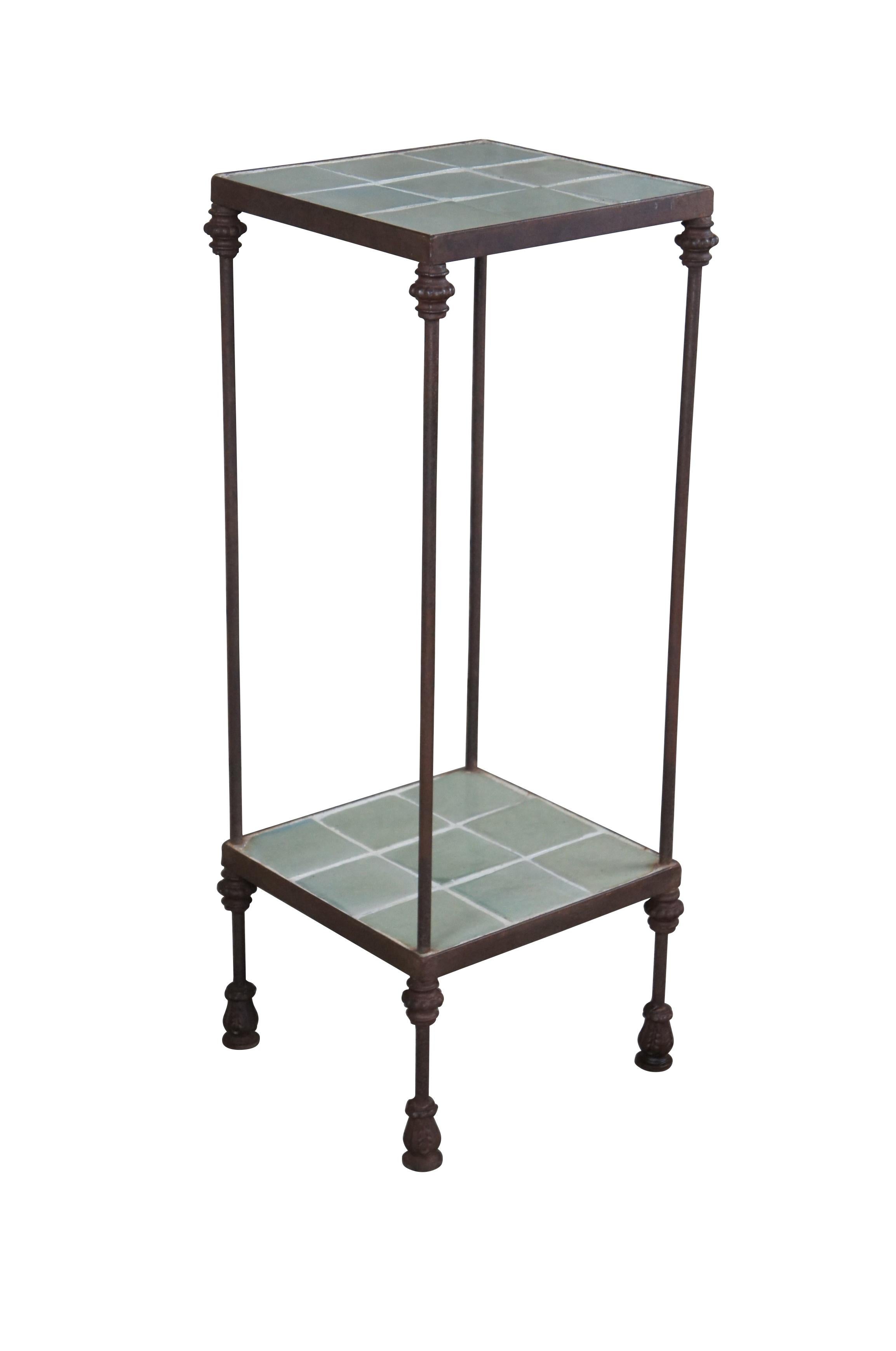 Mid 20th century iron pedestal or stand.  Features a tall open two tier frame with green tiled surfaces.  Great for display of plant or sculptures.  

Dimensions:
14