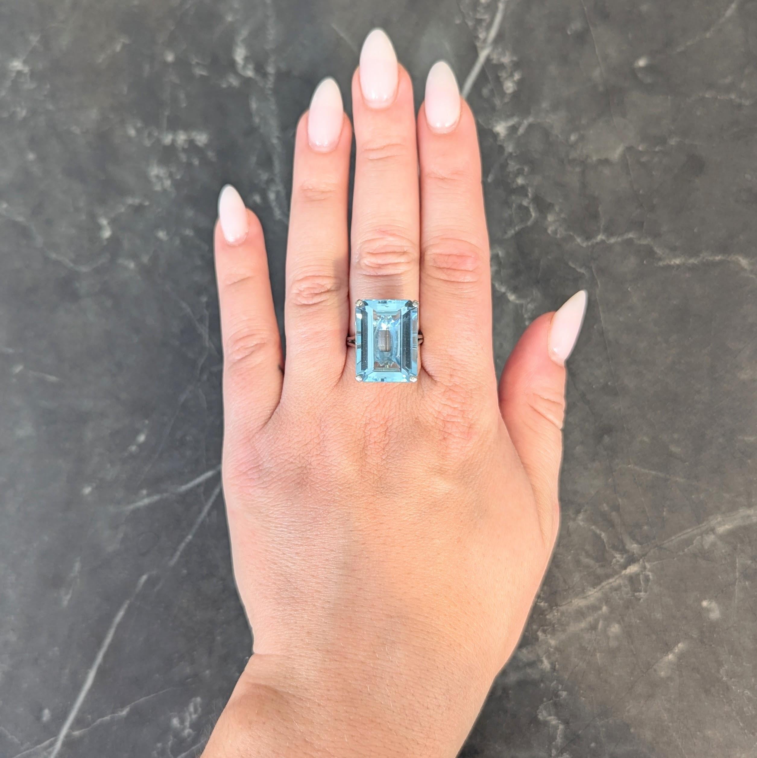 Centering an emerald cut aquamarine weighing approximately 20.65 carats
Transparent light blue in color and prong set in pierced basket
Flanked by split cathedral shoulders
Completed by high polish finish
Stamped for platinum
Circa: 1950s
Ring Size: