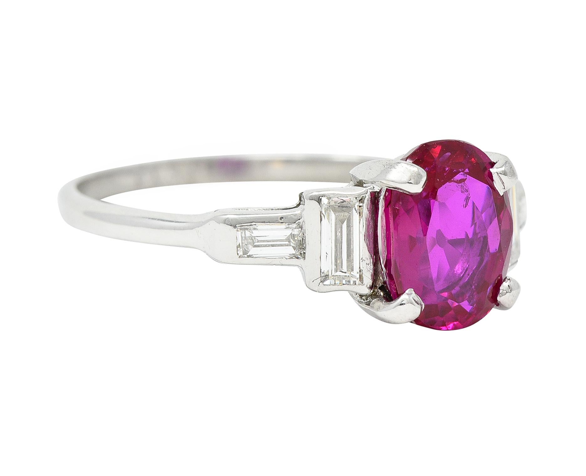 Centering a cushion cut ruby weighing 1.64 carats - medium purplish-red in color 
Natural Burmese in origin with no indications of heat treatment 
Prong set in basket and flanked by stepped shoulders
Bezel set with baguette-cut diamonds 
Weighing