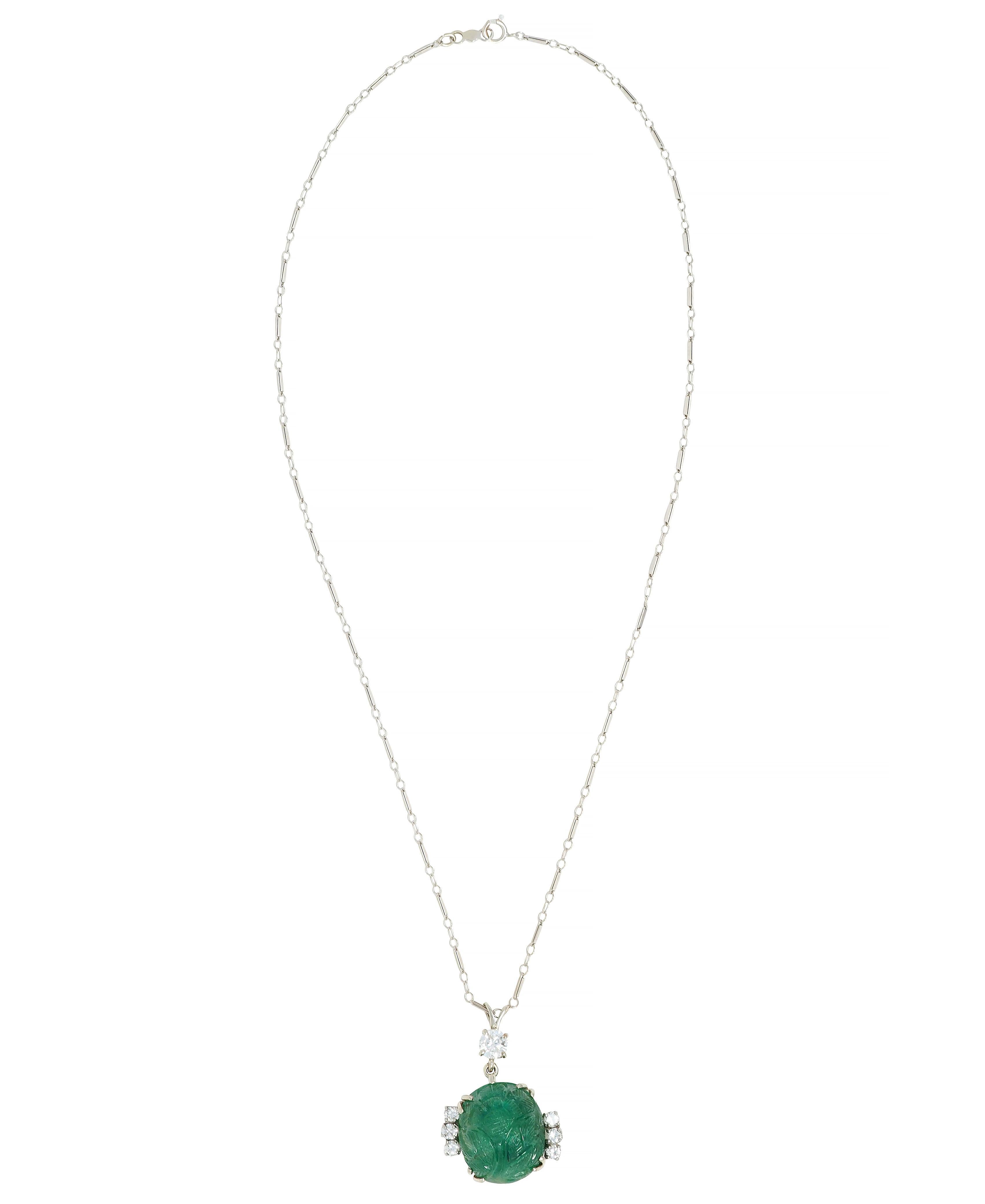 Designed as a fancy bar link chain suspending a pendant centering a carved emerald cabochon
Weighing approximately 20.18 carats total - translucent light to dark green in color 
Carved 